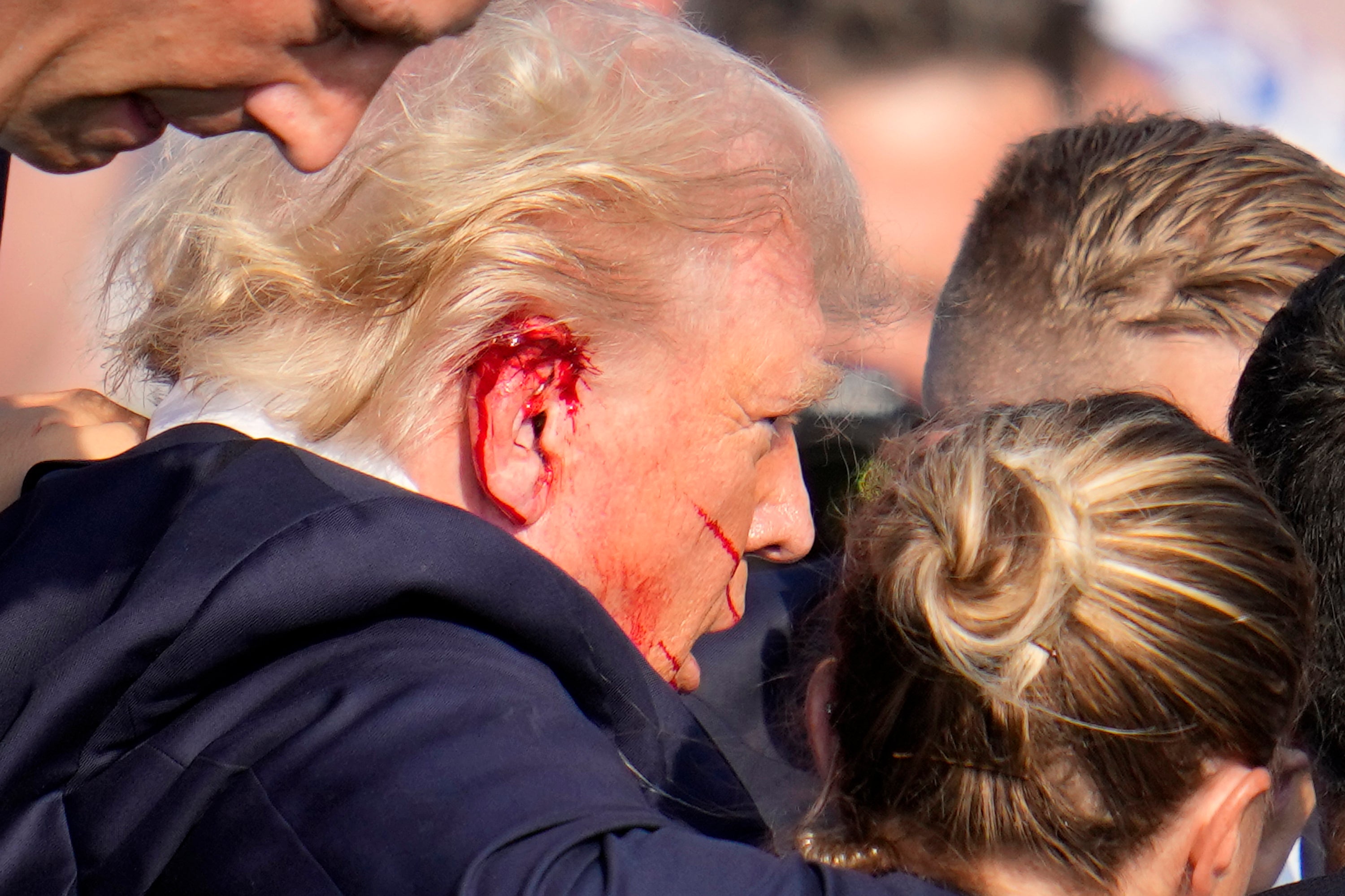 Republican presidential candidate former President Donald Trump is escorted to a motorcade following an attempted assassination at a campaign event in Butler, Pa., on Saturday, July 13, 2024