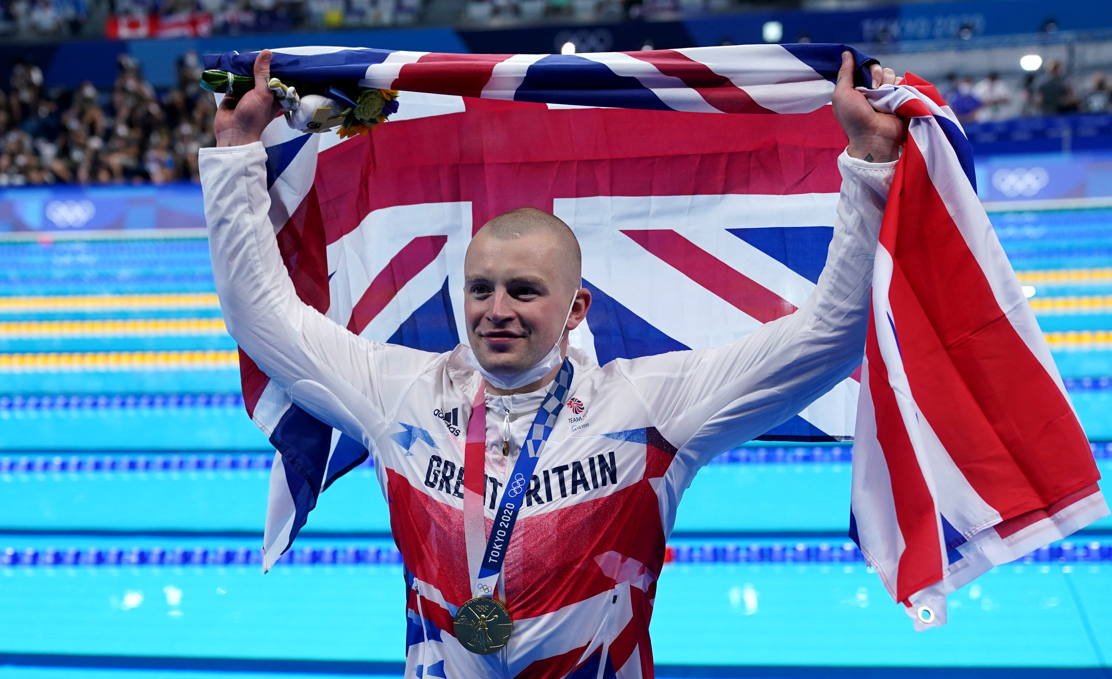 Adam Peaty poses with his gold medal in Tokyo (Adam Davy/PA)