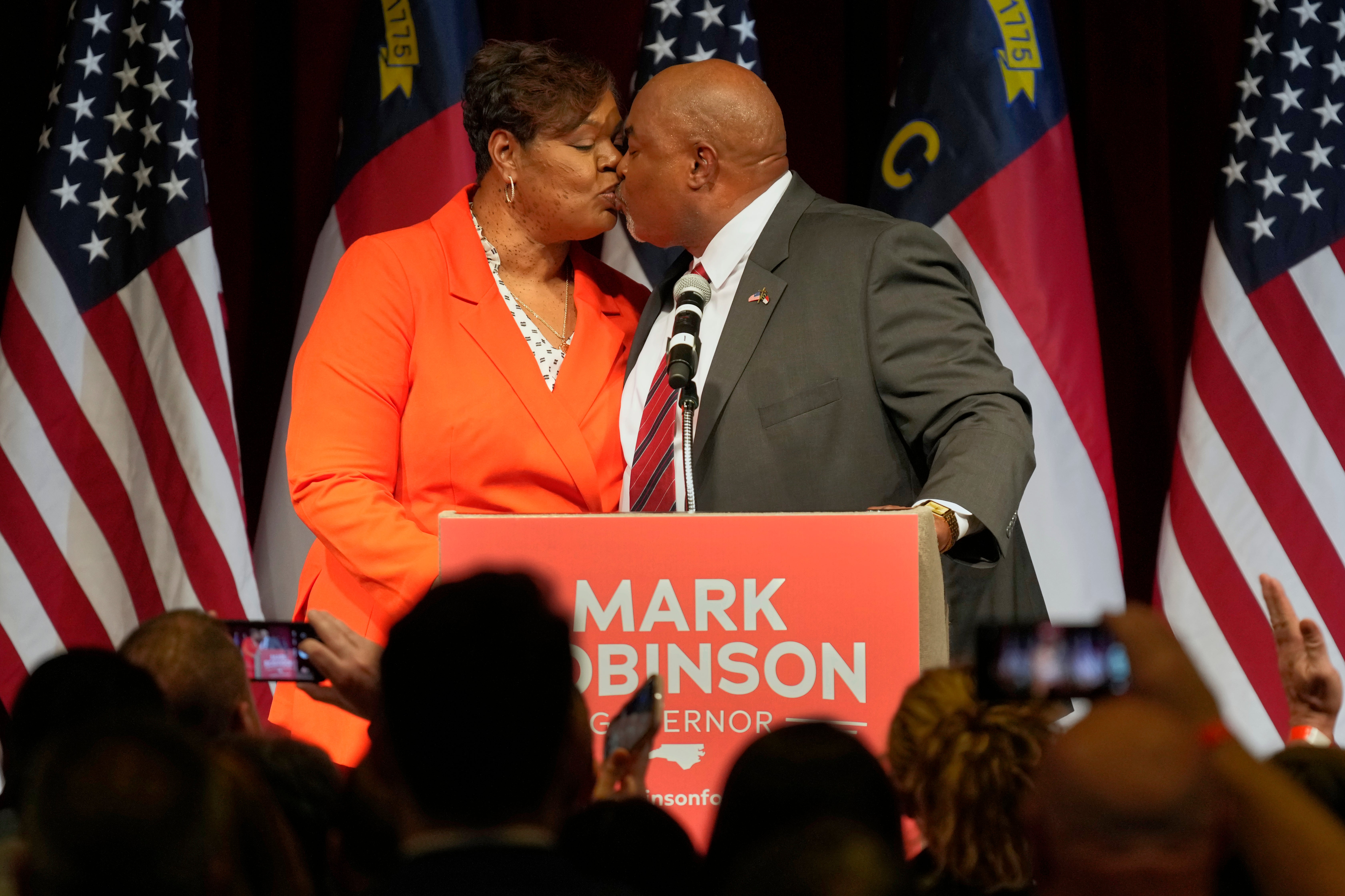 Robinson kisses his wife, Yolanda Hill Robinson. The social conservative, who has taken a stance against promiscuity in the past, wrote, ‘yeah, I’m a perv too’ on the forum, according to a report