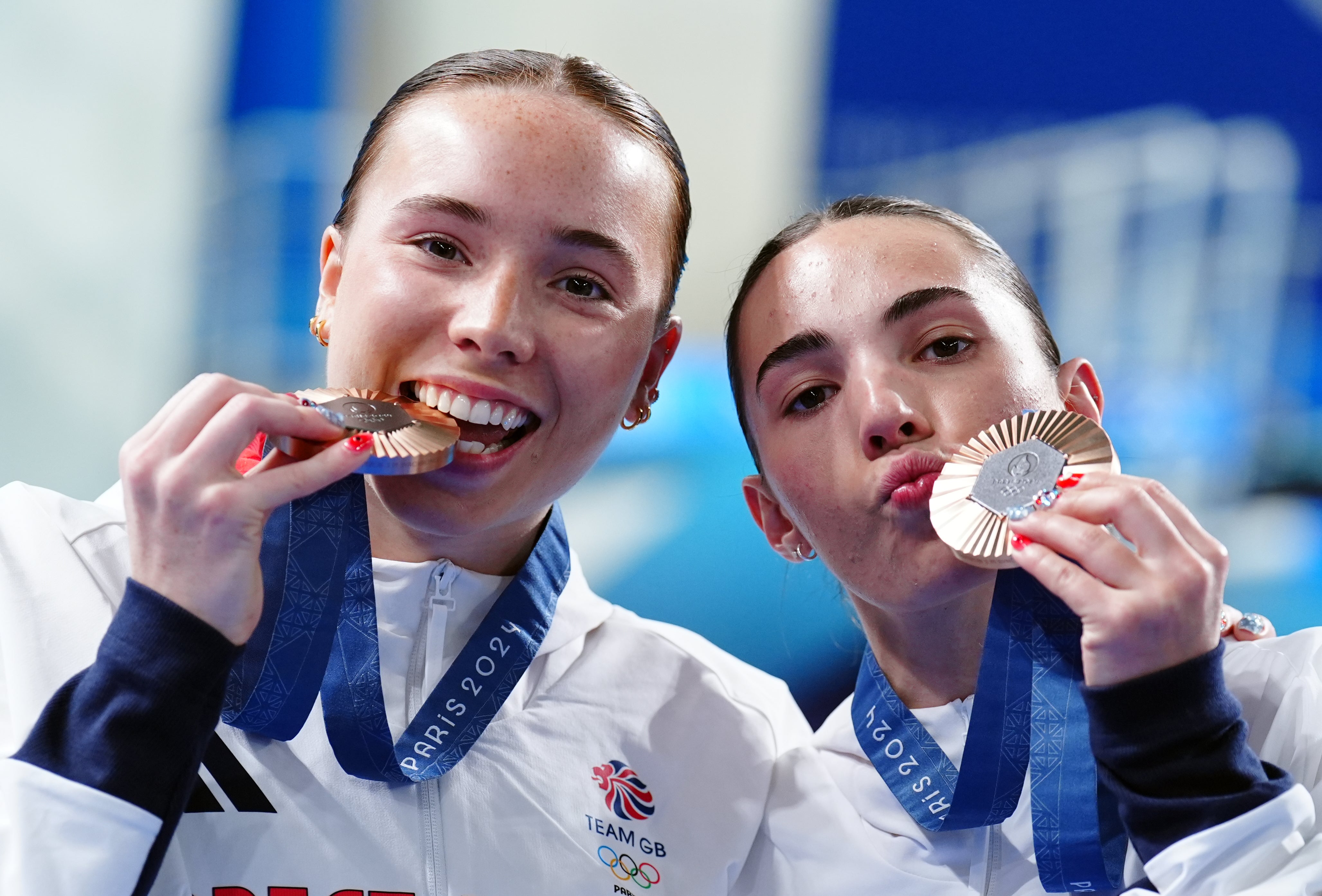 Sealed with a kiss – Great Britain’s Yasmin Harper and Scarlett Mew Jensen with their bronze medals (Mike Egerton, PA)