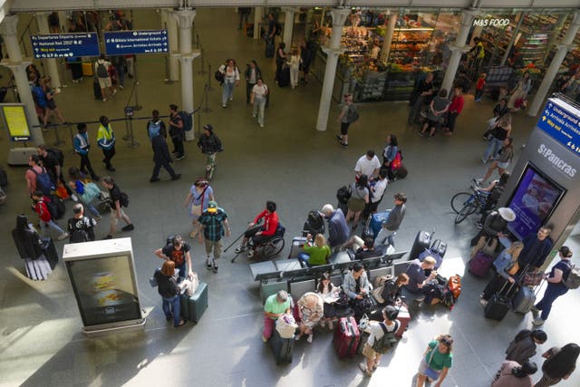 Passengers at the Eurostar terminal at St Pancras station in central London waiting for their trains (Maja Smiejkowska/PA)