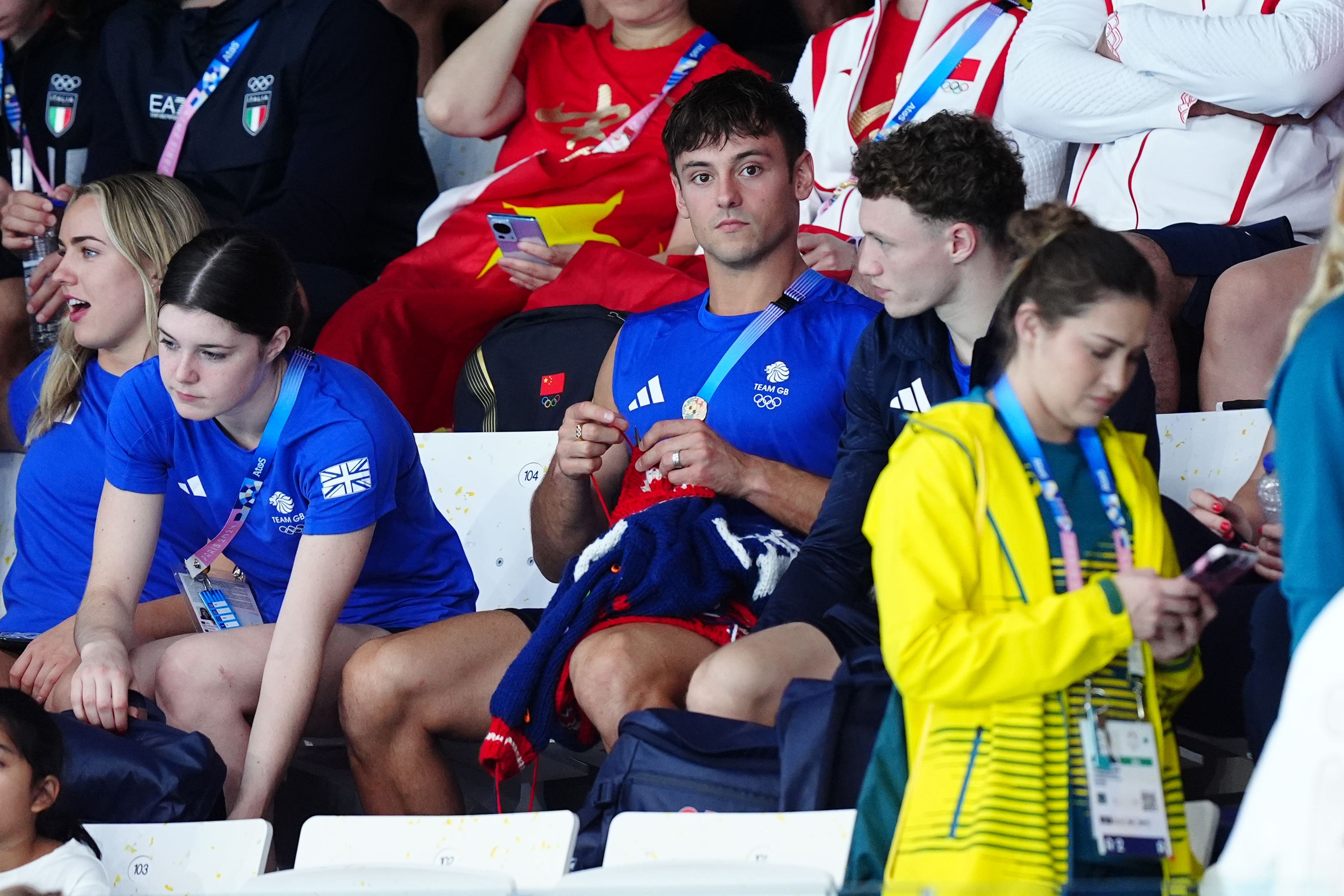 Tom Daley knitting as he watches the women’s synchronised 3m springboard final at the Aquatics Centre on the first day of the 2024 Paris Olympic Games (Mike Egerton/PA)