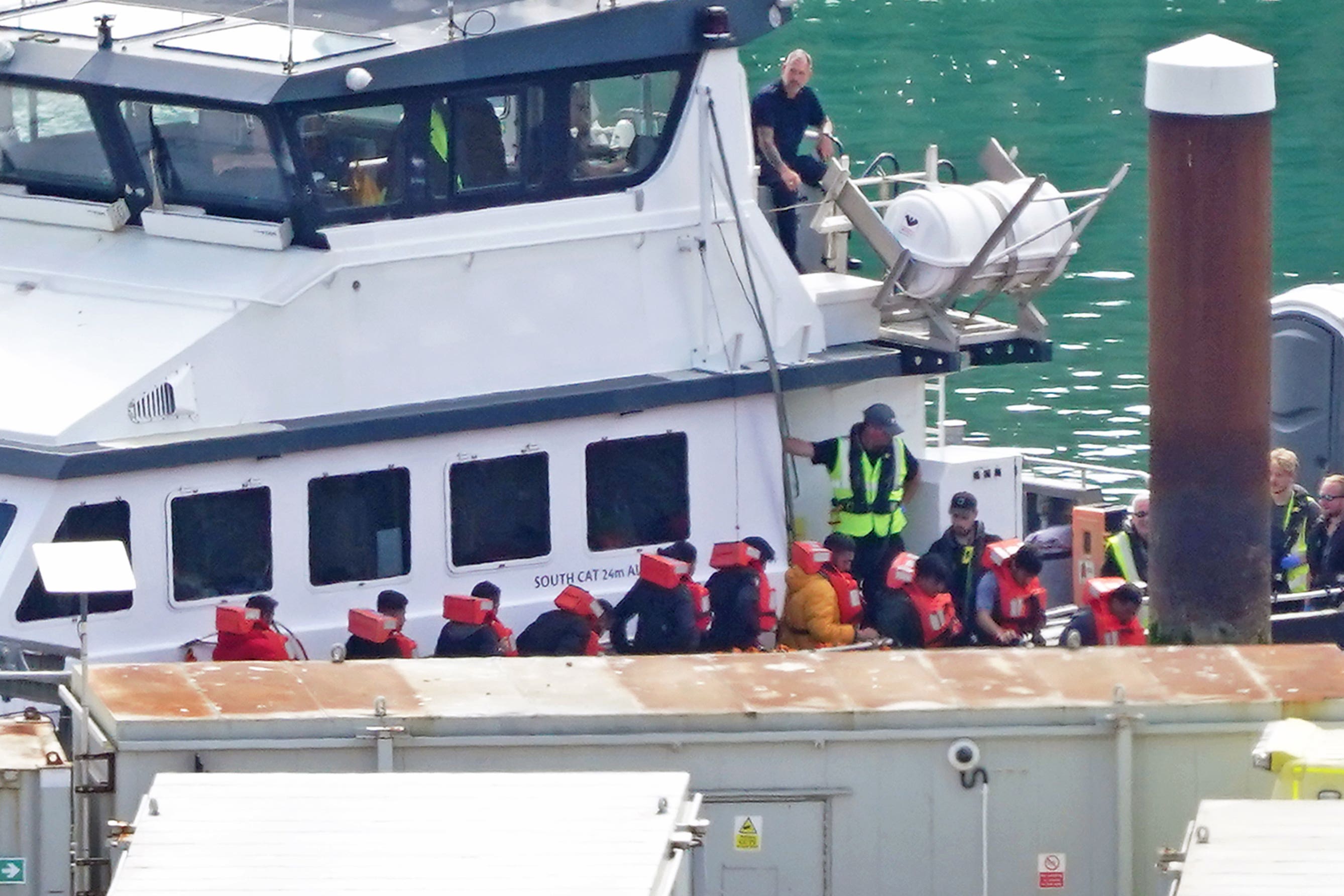 A group of people thought to be migrants are brought in to Dover on a Border Force vessel (Gareth Fuller/PA)