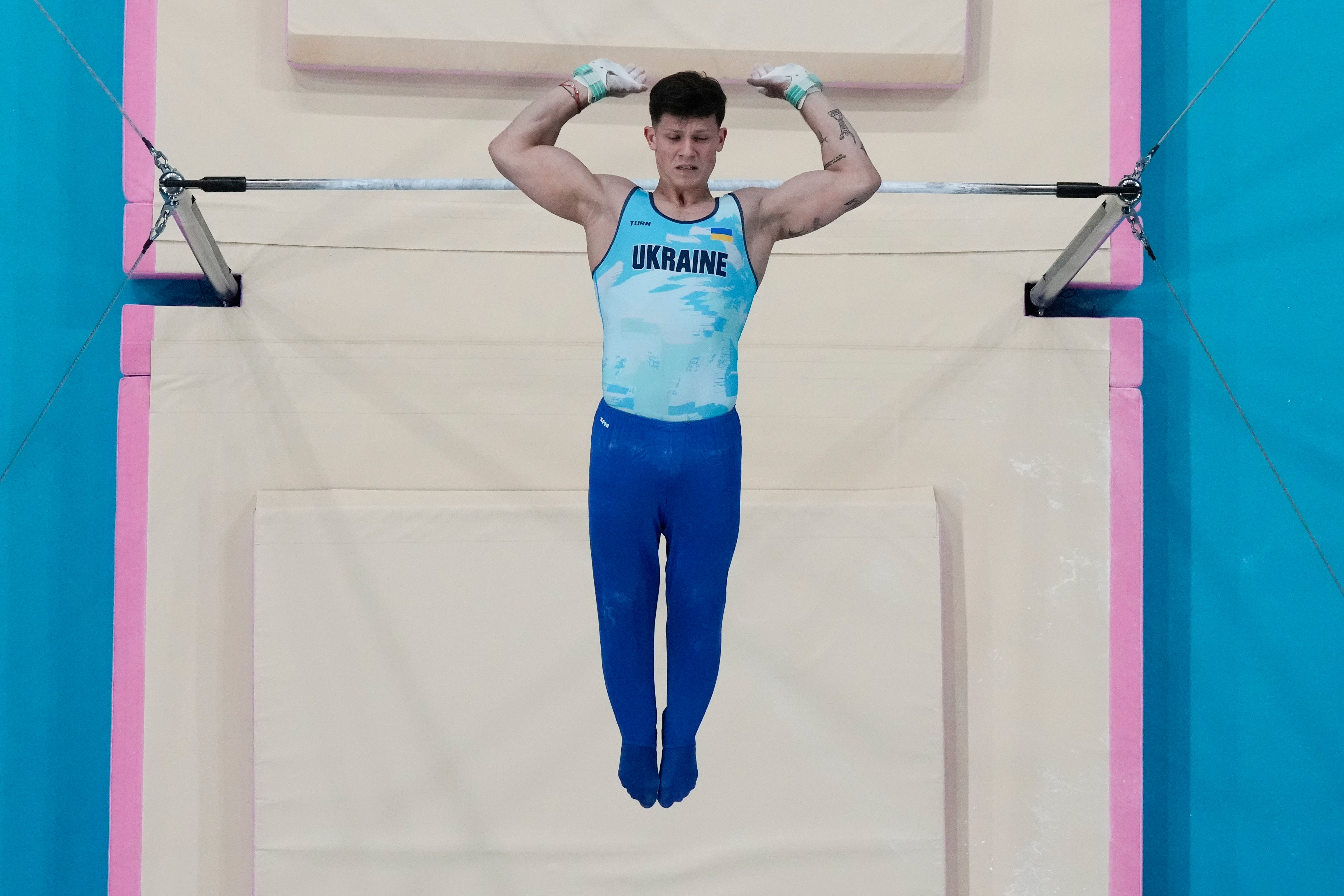 Illia Kovtun of Ukraine performs on the bars during a men's artistic gymnastics qualification round at the 2024 Summer Olympics