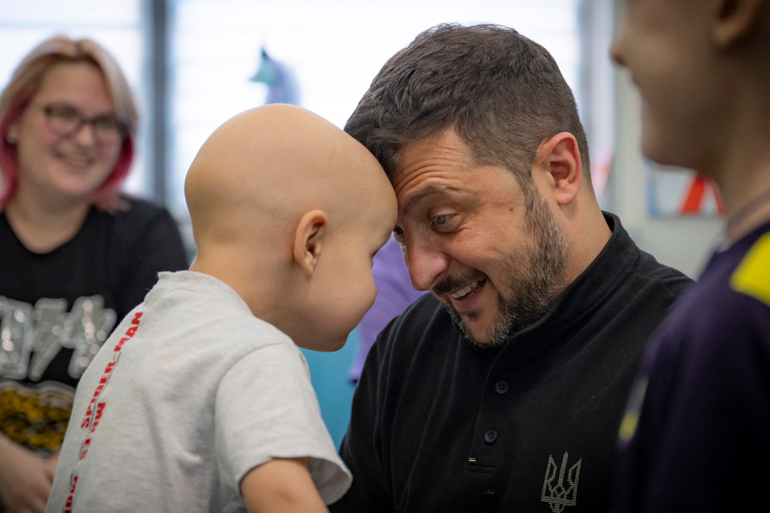 Ukraine's President Volodymyr Zelensky plays with a child during his visit to the Ohmatdyt Children's Hospital in Kyiv,