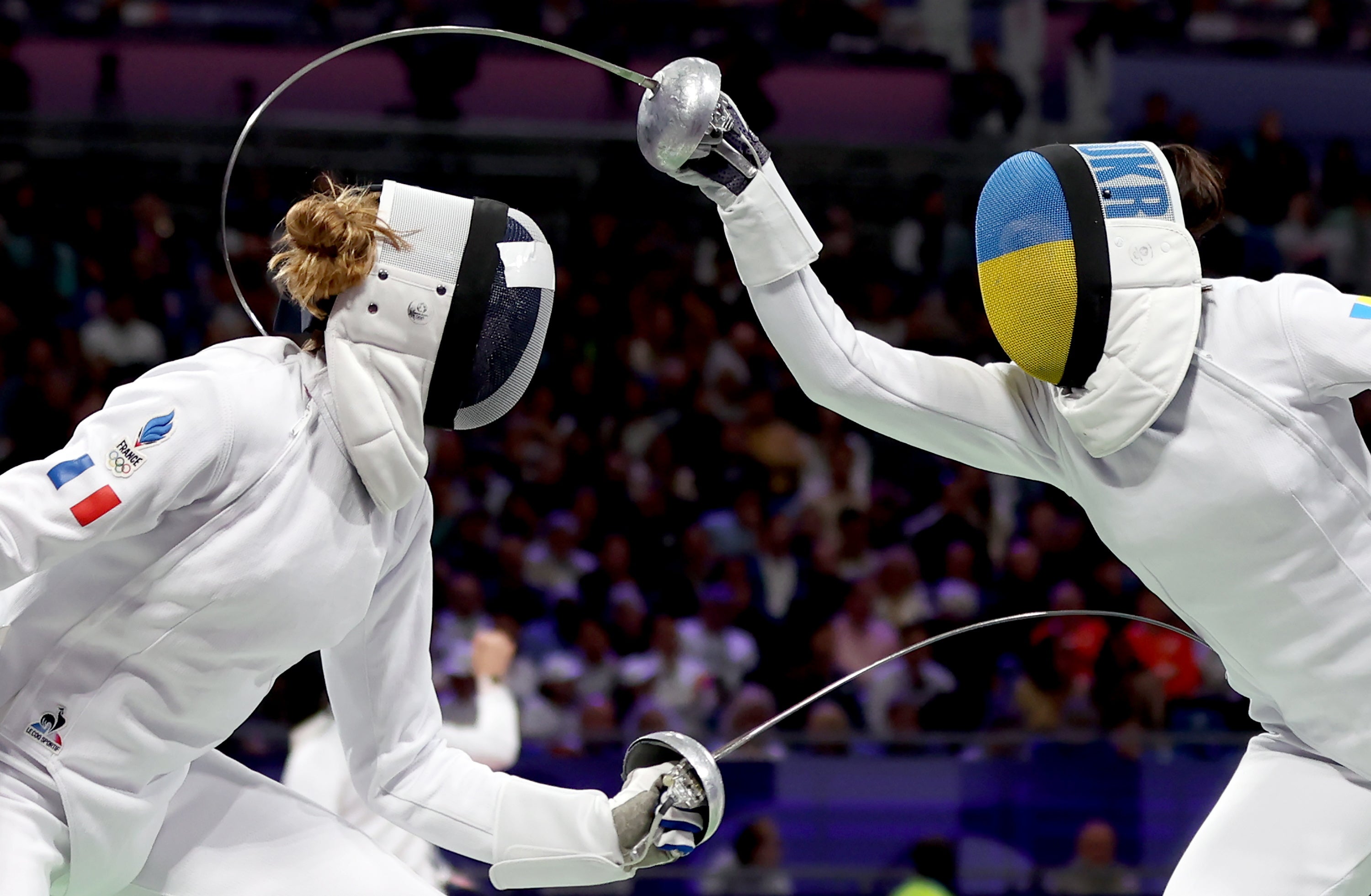 France's Auriane Marot Breton (left) competes against Ukraine's Vlada Kharkova in the women's individual epee quarterfinals.