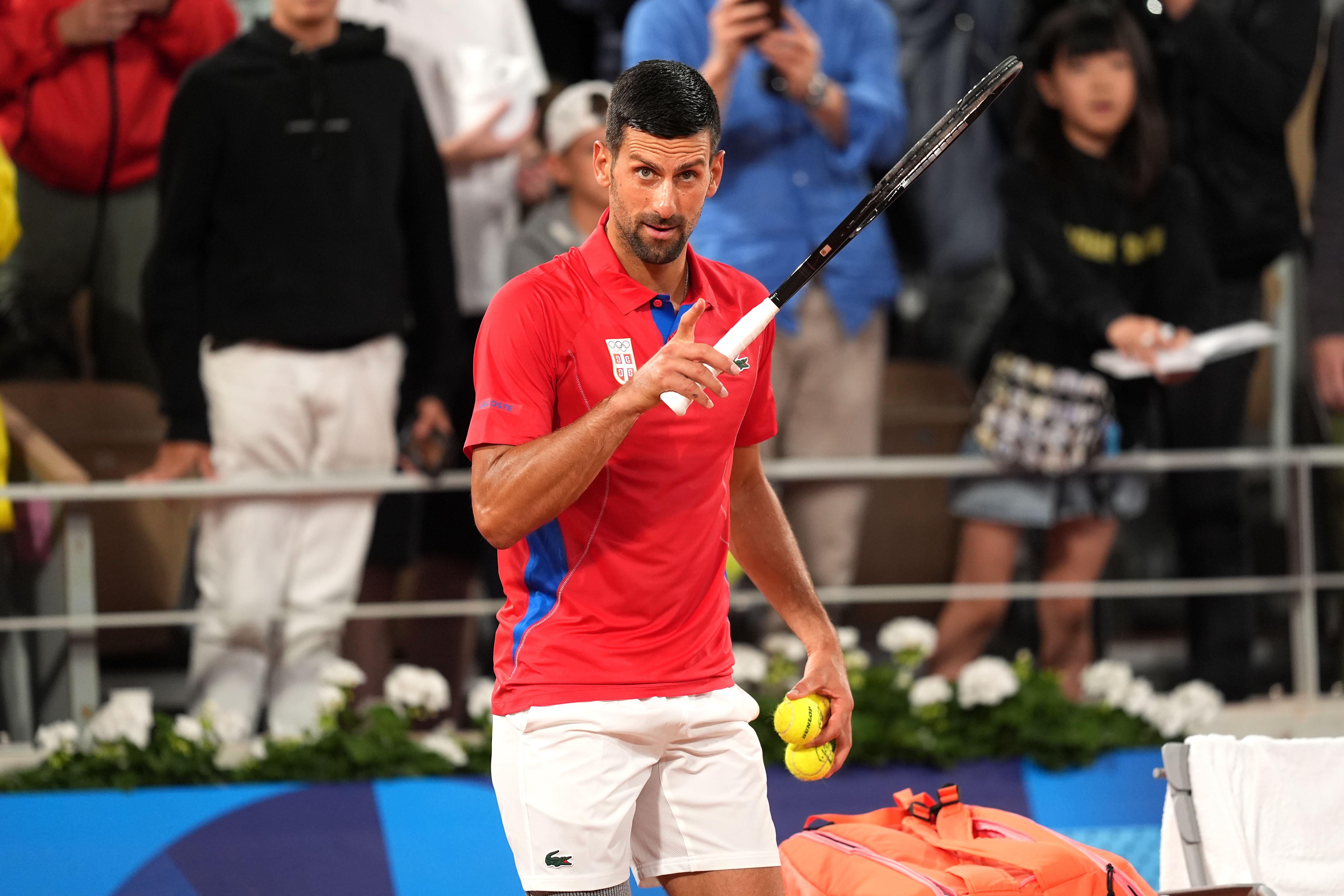 Novak Djokovic eased to victory in the first round but criticised the entry rules