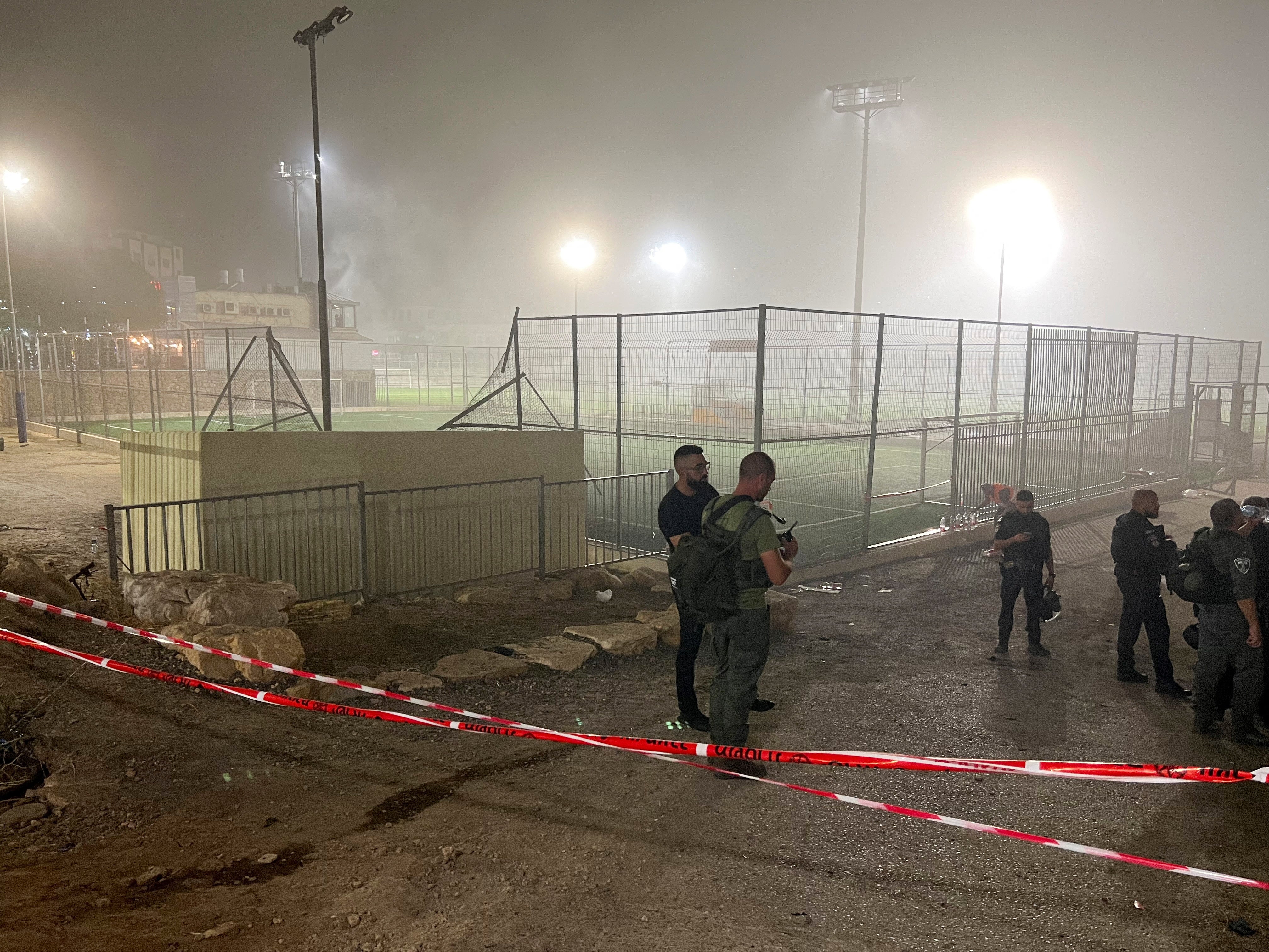 Israeli security and military officials respond after rockets were launched at a football pitch in the Golan Heights