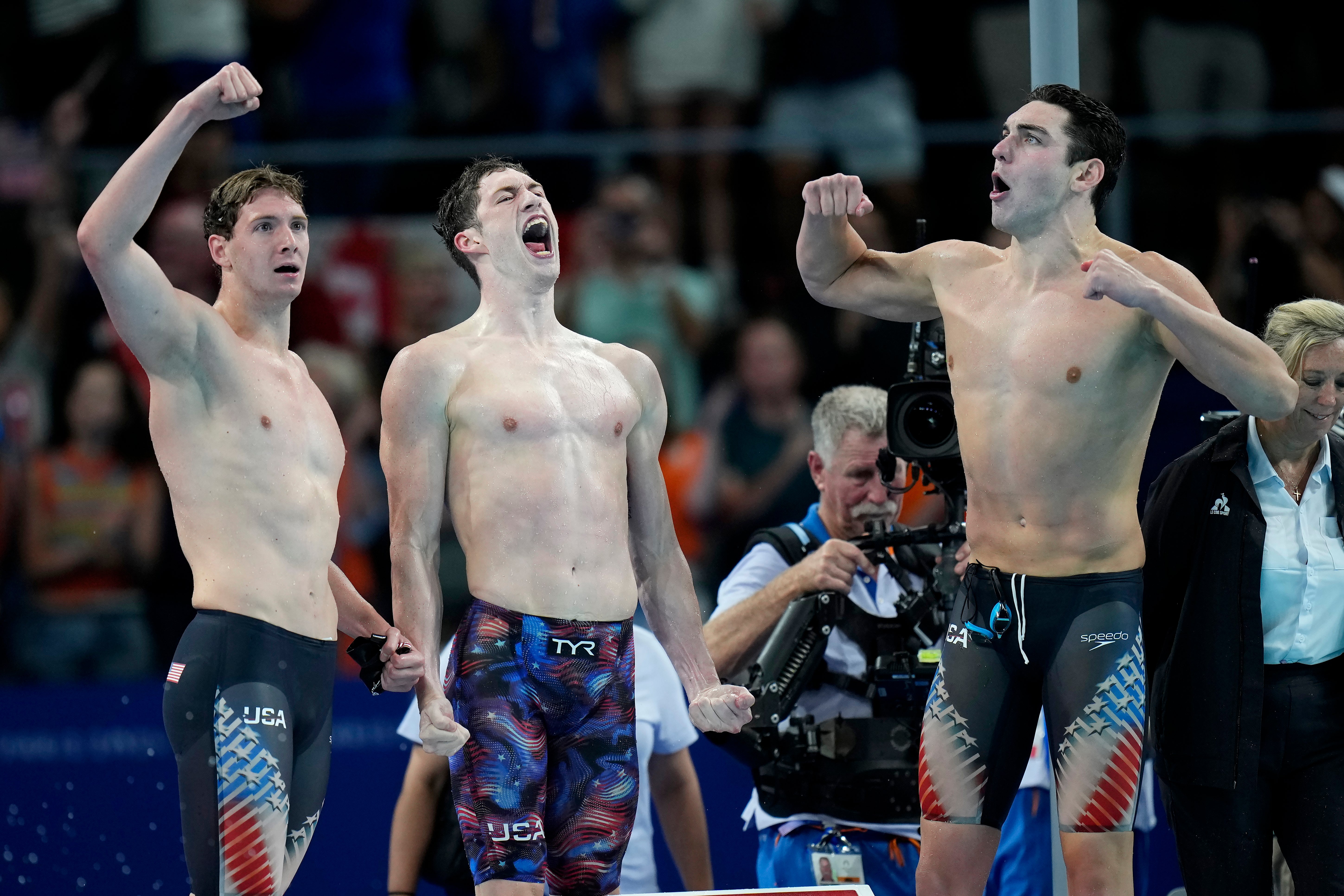 Members of the United States men's 4x100-meter freestyle relay team react after winning the gold medal at the 2024 Summer Olympics, Saturday, July 27