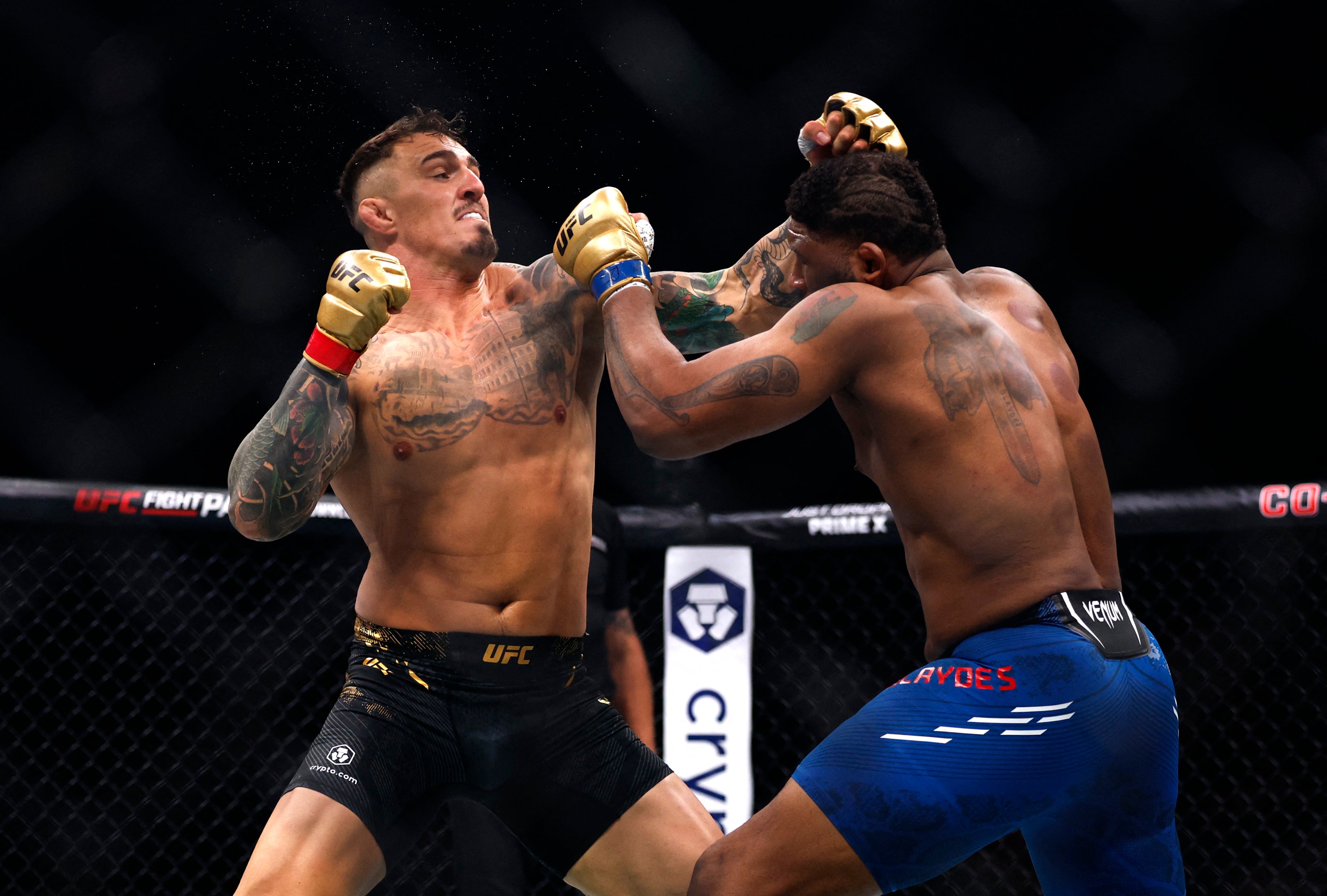 Tom Aspinall (left) drops Curtis Blaydes before sealing the knockout