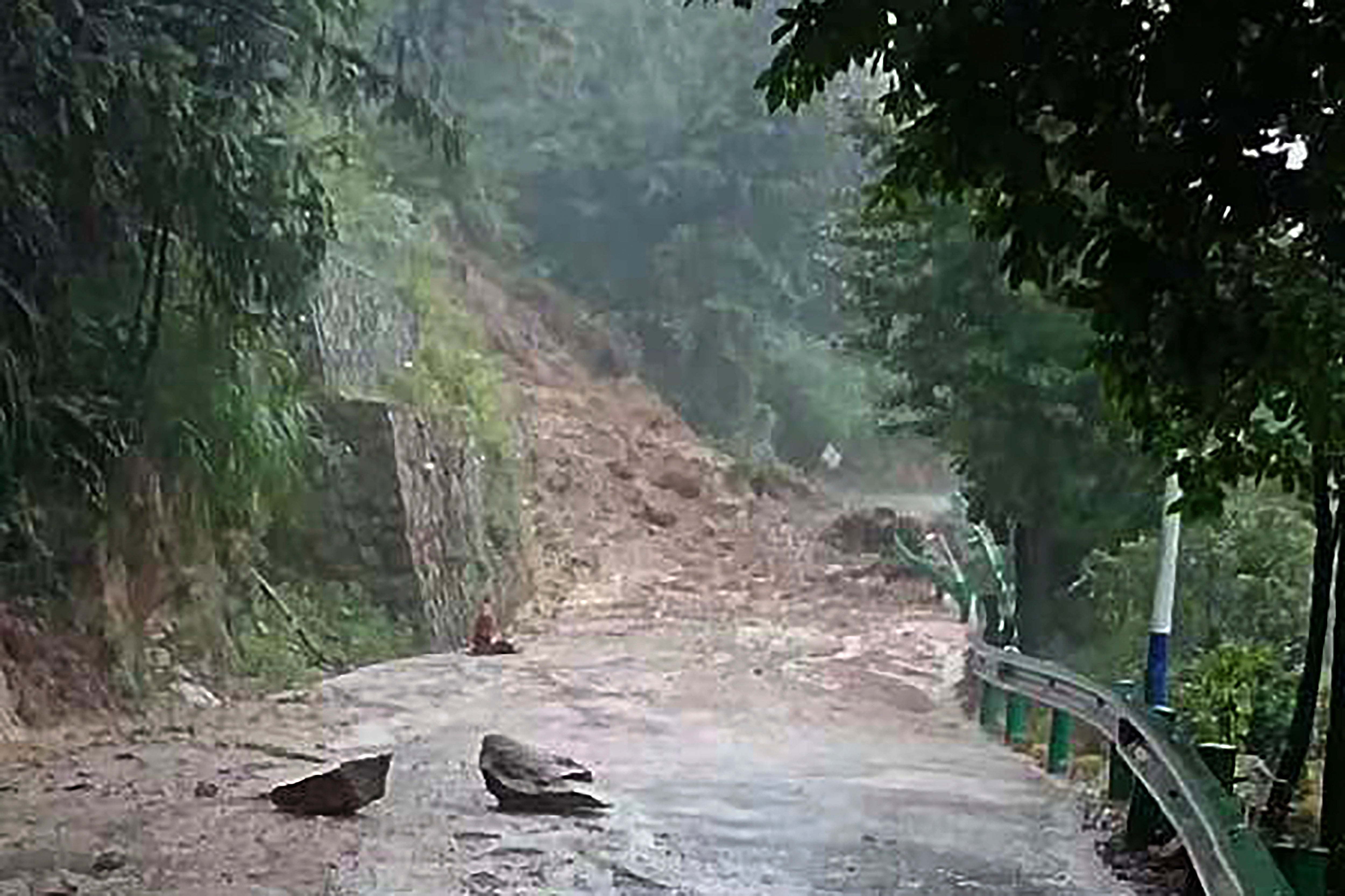 Photo released by Xinhua shows landslide blocking a road in Shouyue town in central China’s Hunan province on 28 July 2024