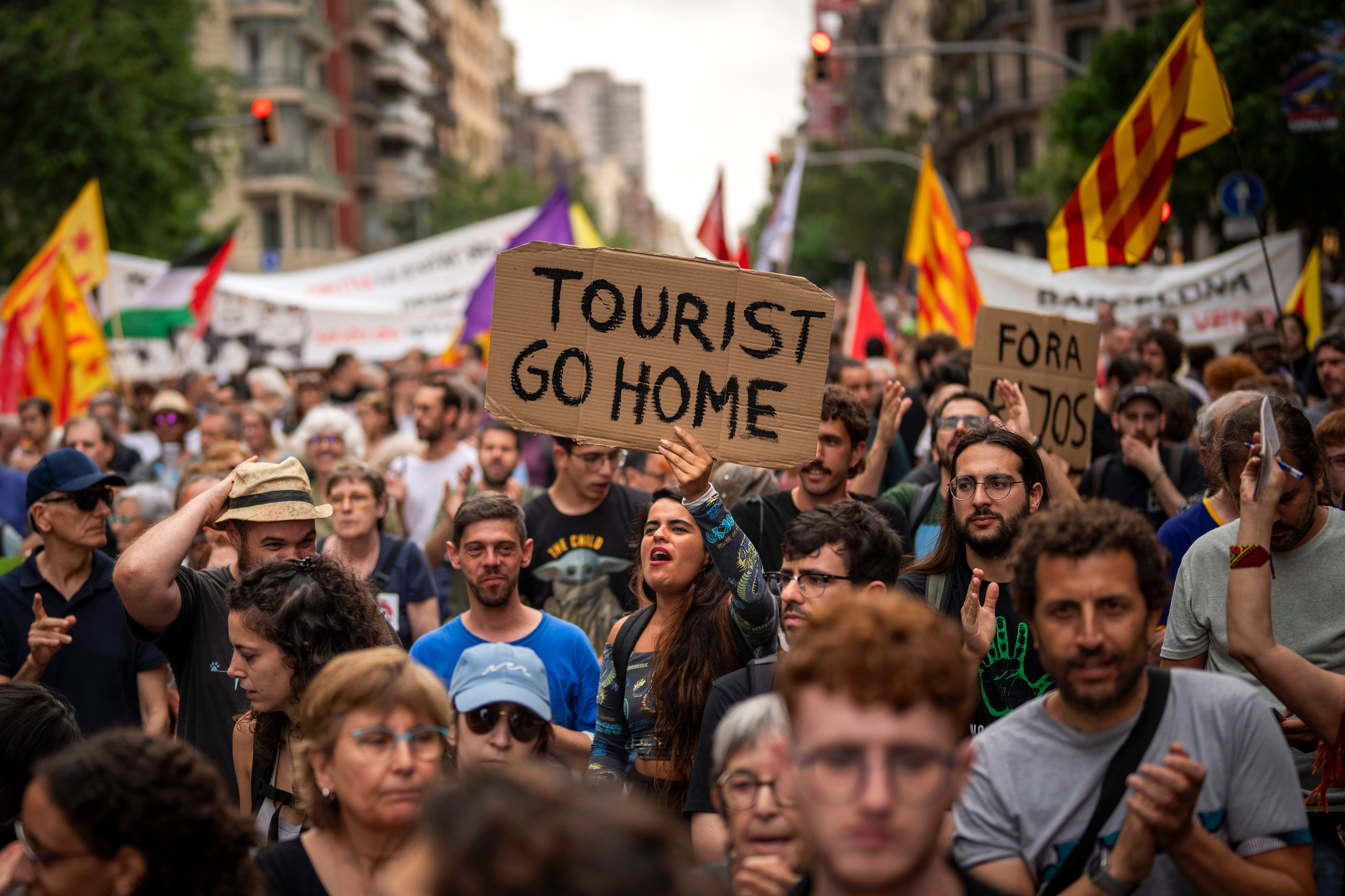 Demonstrators march shouting slogans against the Formula 1 Barcelona Fan Festival in downtown Barcelona, Spain