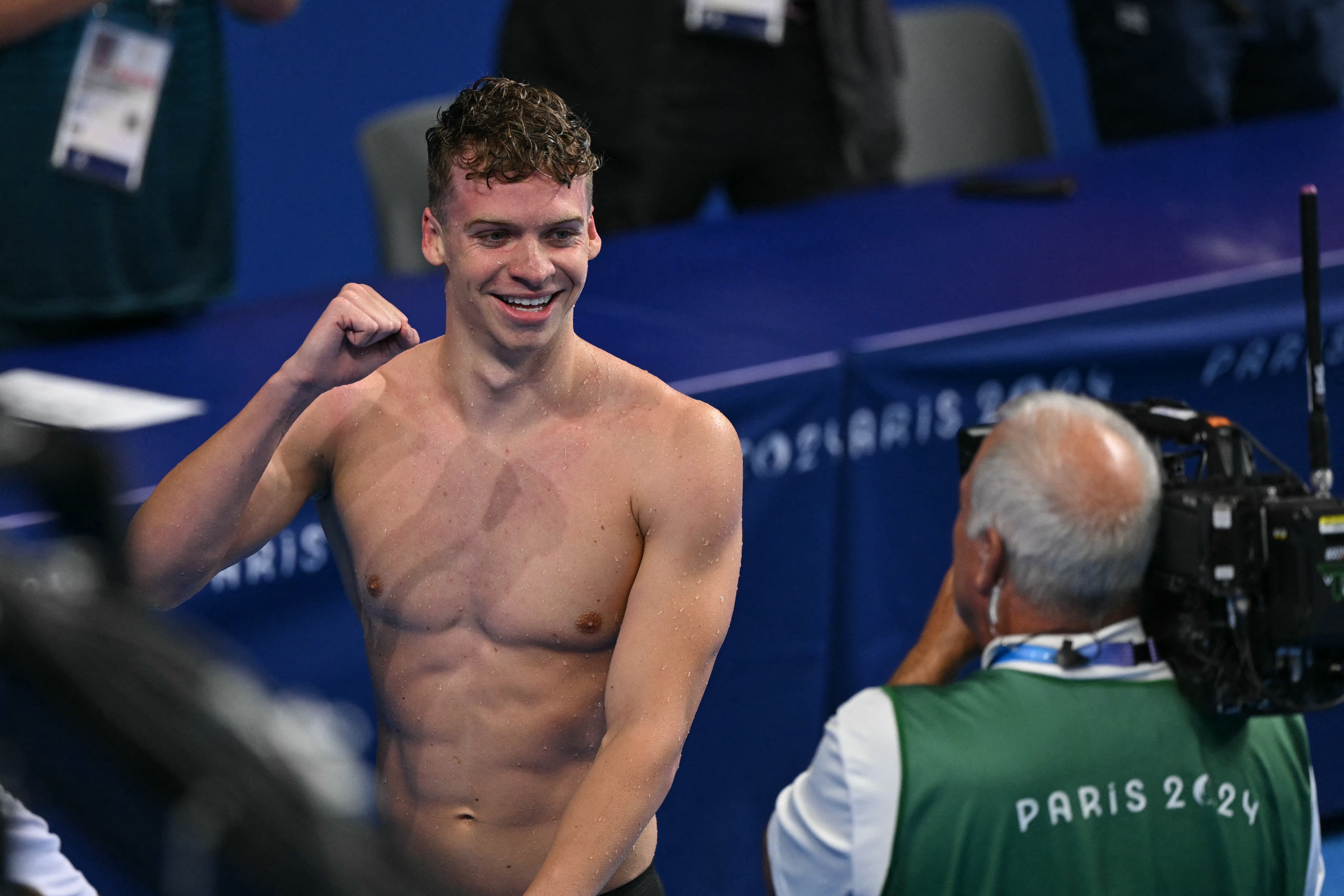 France's Leon Marchand celebrates after winning the final of the men's 400m individual medley