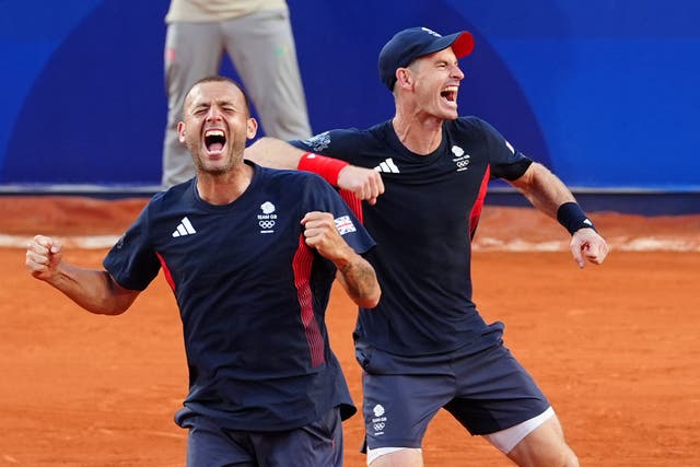 Andy Murray, right, and Dan Evans, celebrate their amazing victory (Peter Byrne/PA)