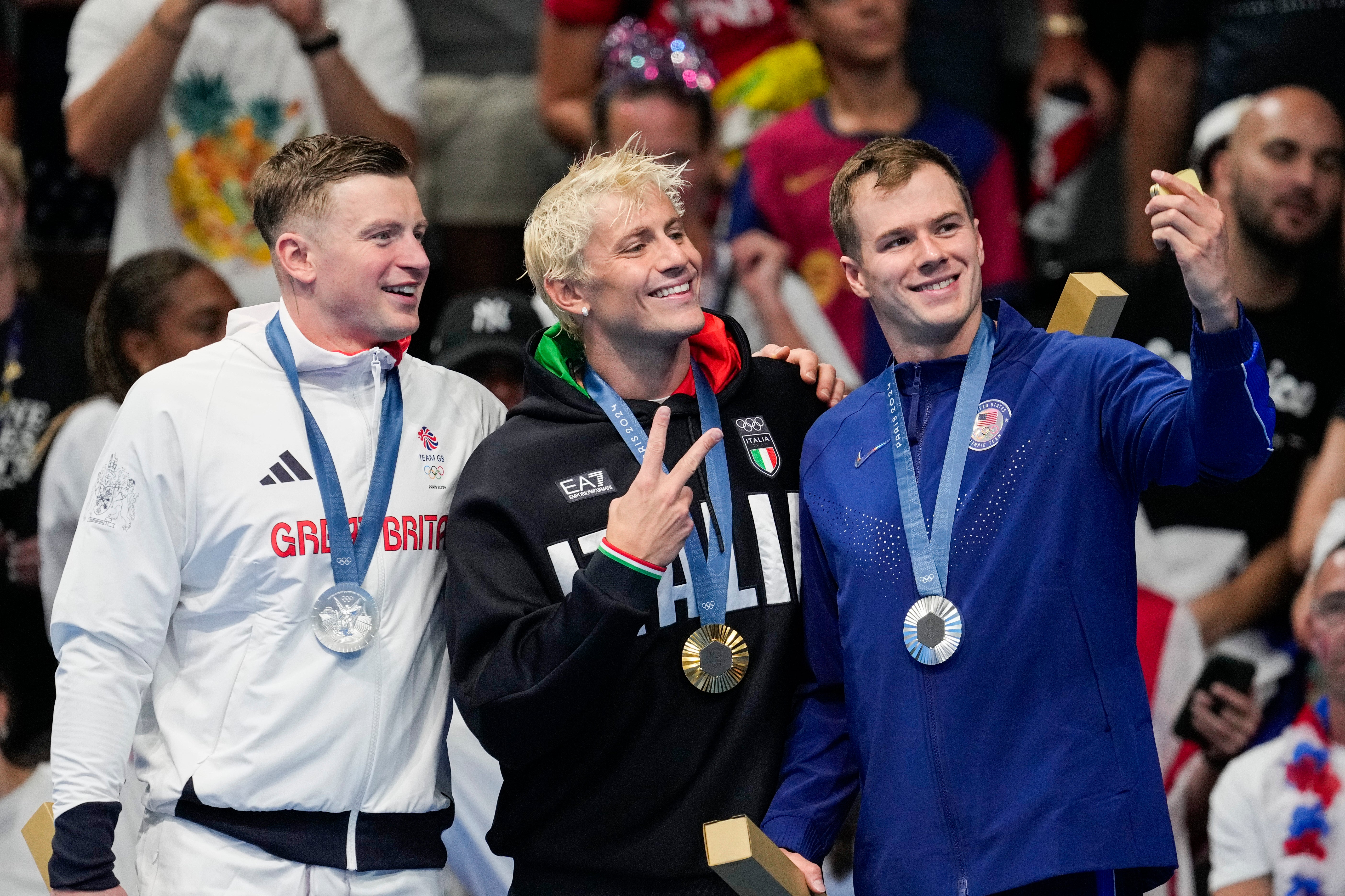 Gold medalist, Nicolo Martinenghi, center, of Italy, stands with silver medalists, Nic Fink, right, of the the United States, and Adam Peaty, of Britain