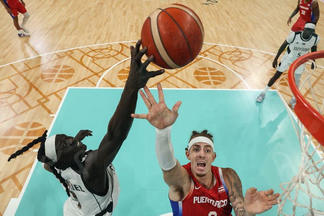 <p>South Sudan’s #09 Wenyen Gabriel (L) fights for the ball with Puerto Rico’s #0 Isaiah Pineiro in the men’s preliminary round group C basketball match between South Sudan and Puerto Rico</p>