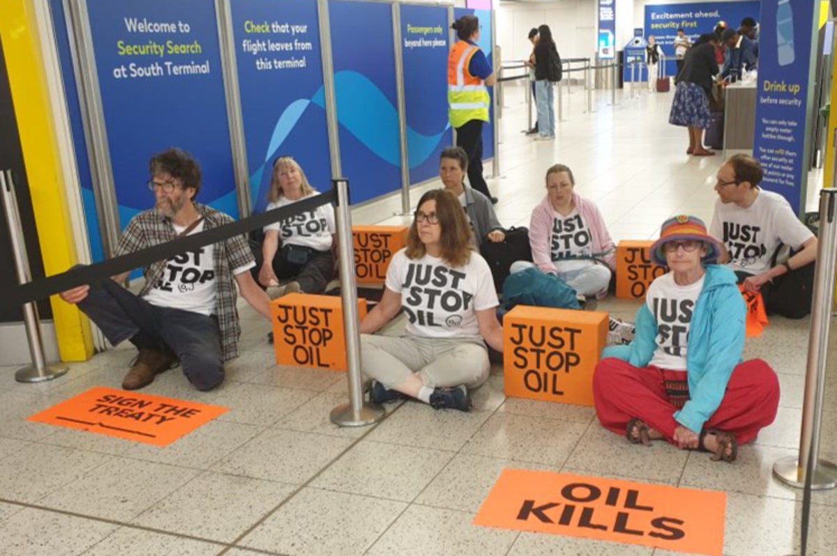 Gatwick passengers step over Just Stop Oil activists blocking airport entrance