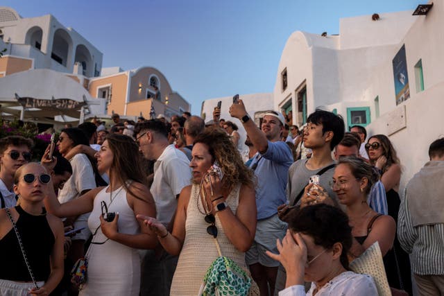 <p>Tourists view Santorini’s famed sunset, on Santorini, Greece, July 25, 2024. REUTERS/Alkis Konstantinidis</p>