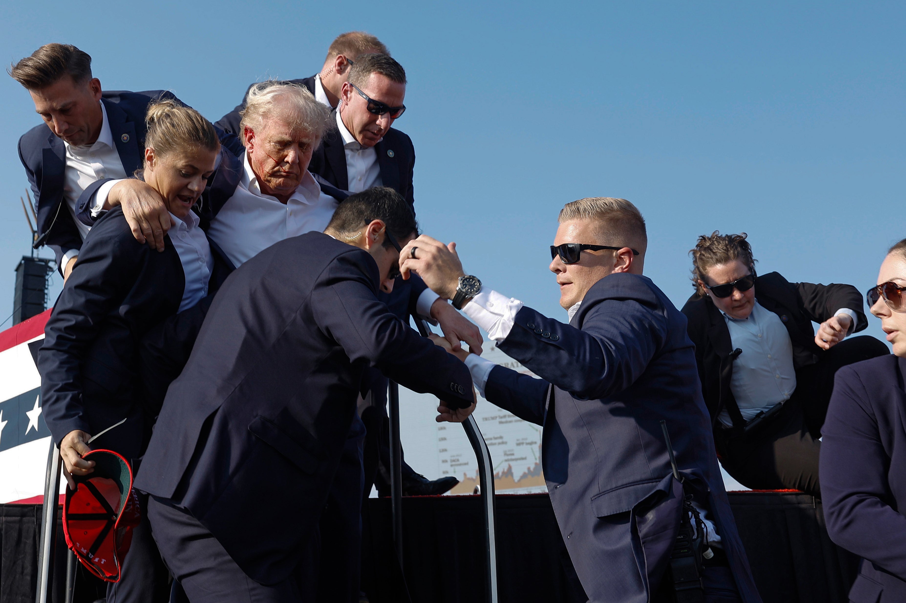 Trump is rushed offstage by Secret Service agents after being grazed by a bullet during a rally. There have been numerous reports about how the shooter was spotted well before he opened fire