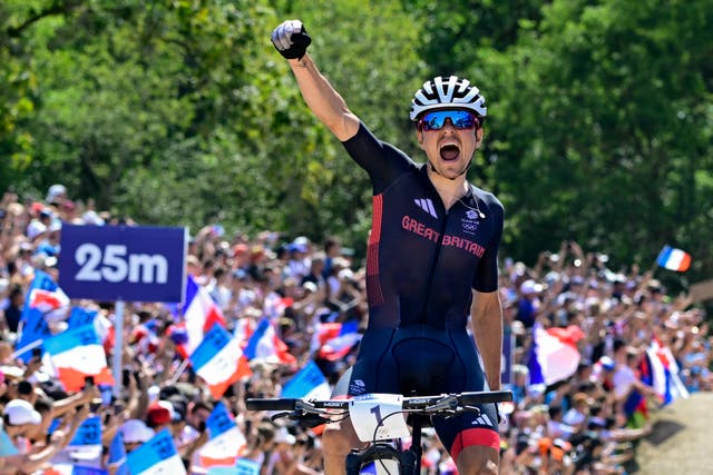 <p>Tom Pidcock celebrates as he crosses the line at Elancourt Hill</p>