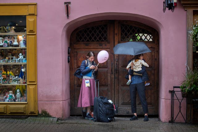 <p>People shelter from the rain in Vilnius, Lithuania, Monday, July 29, 2024</p>