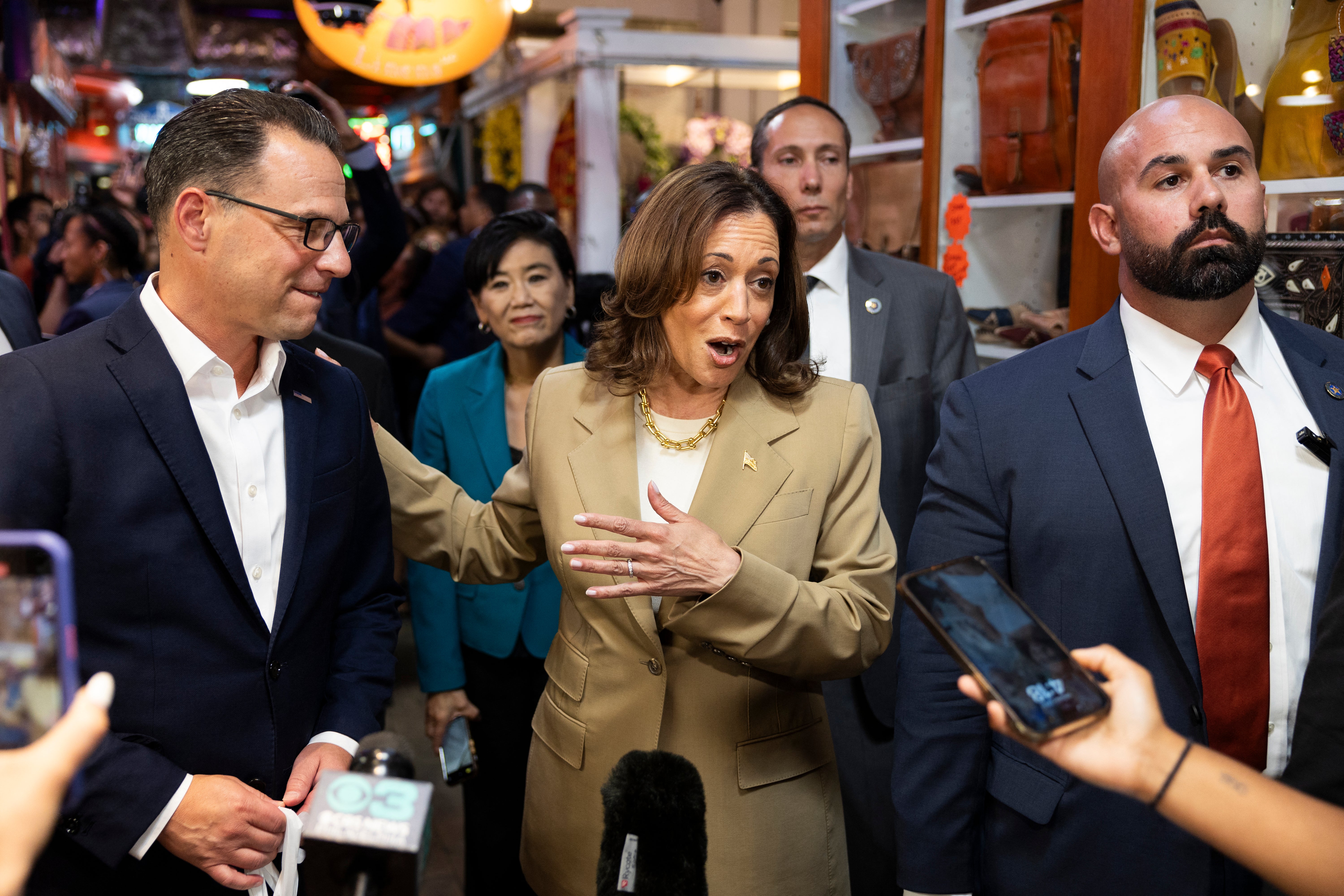 Vice President Kamala Harris and Pennsylvania Governor Josh Shapiro (L) speak to the press while making a stop at the Reading Terminal Market in Philadelphia, Pennsylvania, July 13, 2024.