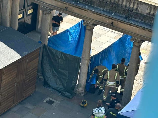 <p>Handout photo courtesy of Chinua Thompson of the emergency services at the scene on Stall Street in Bath, after two people fell ill after being approached by a woman with a bag</p>