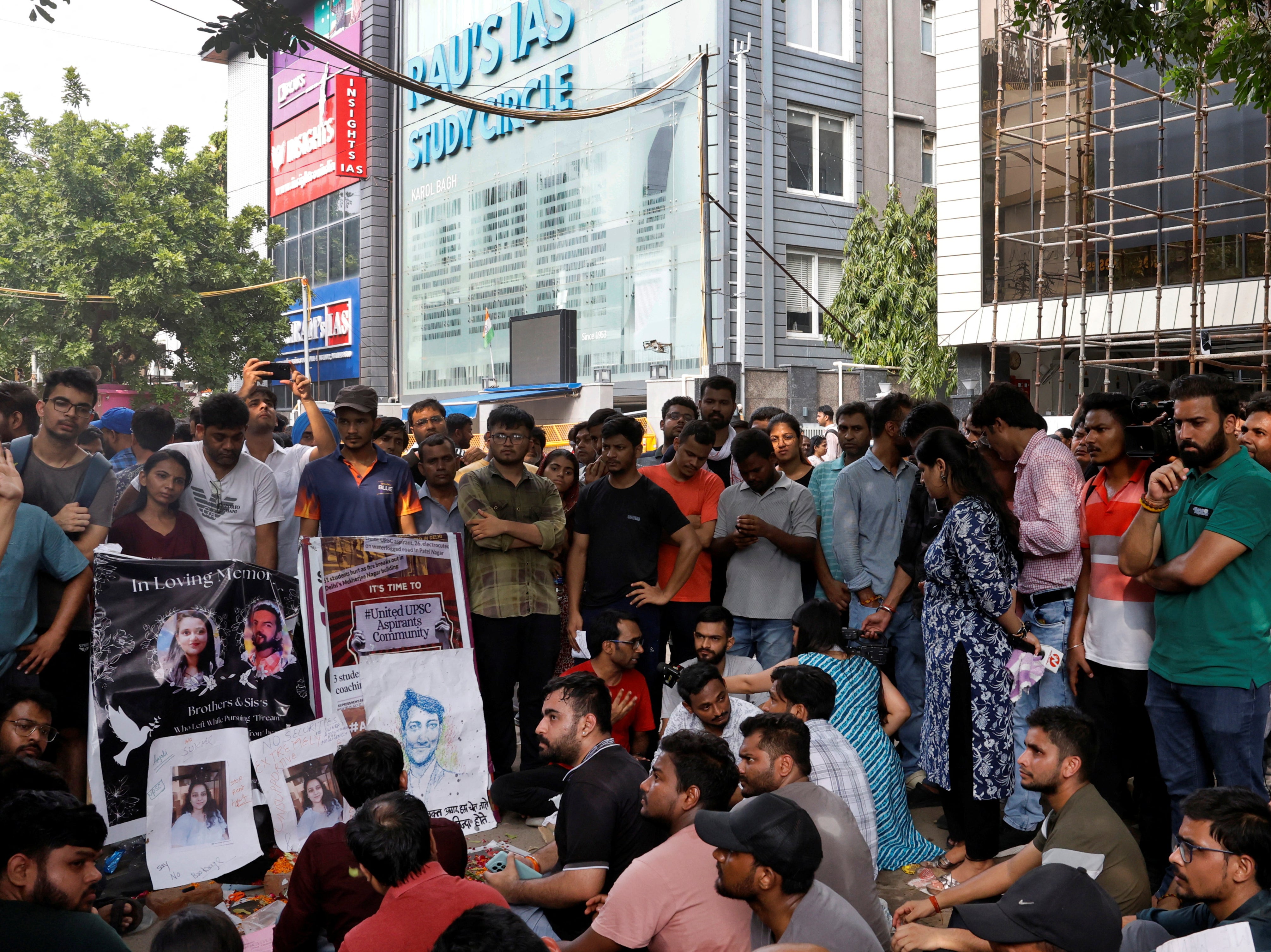 Students protest outside a coaching centre in Delhi, India