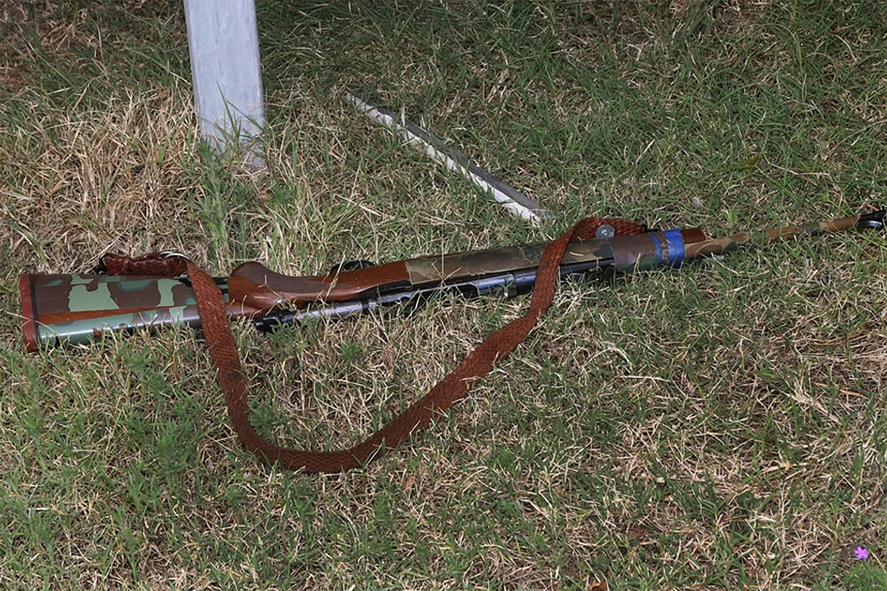 In this undated photo provided by the Queensland Department of Justice and Attorney-General a rifle lays on the ground at a rural property at Wieambilla, Australia