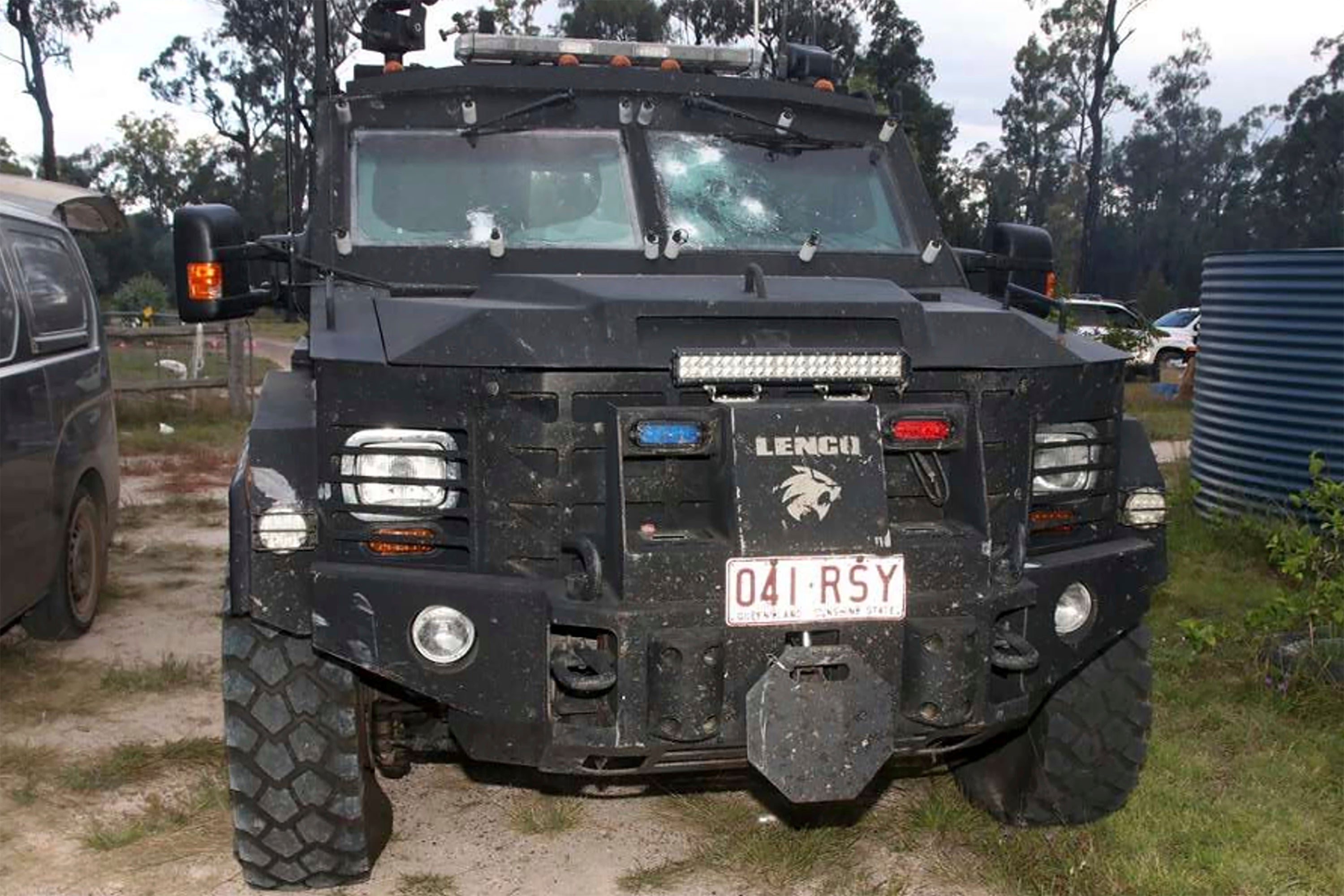 In this undated photo provided by the Queensland Department of Justice and Attorney-General an armored police vehicle is damaged from gunshots at a rural property at Wieambilla, Australia