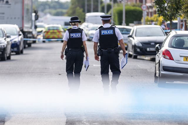 <p>Police officers near the scene of the knife attacks in Hart Street, Southport</p>