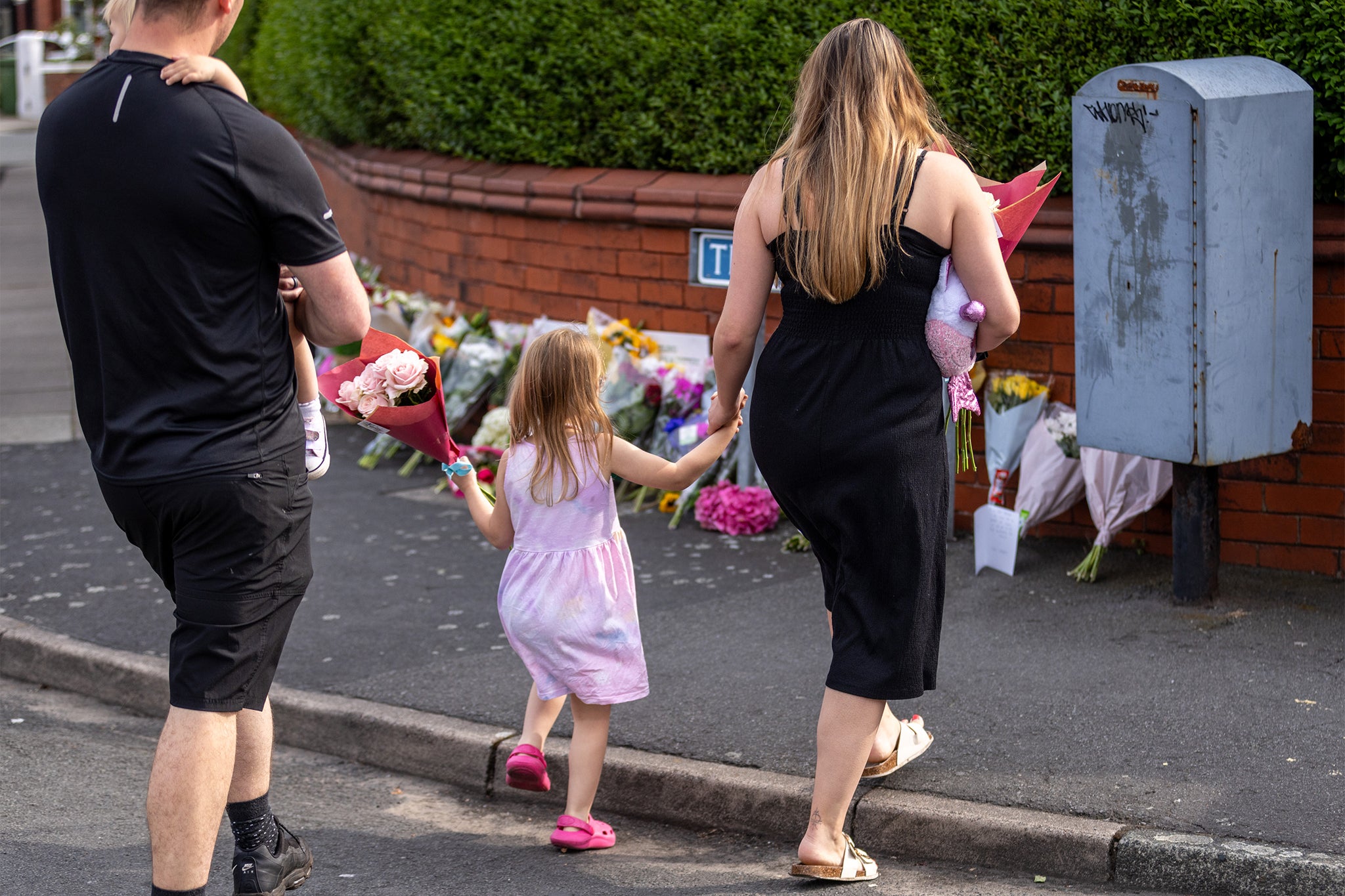 People leave flowers near the scene in Hart Street