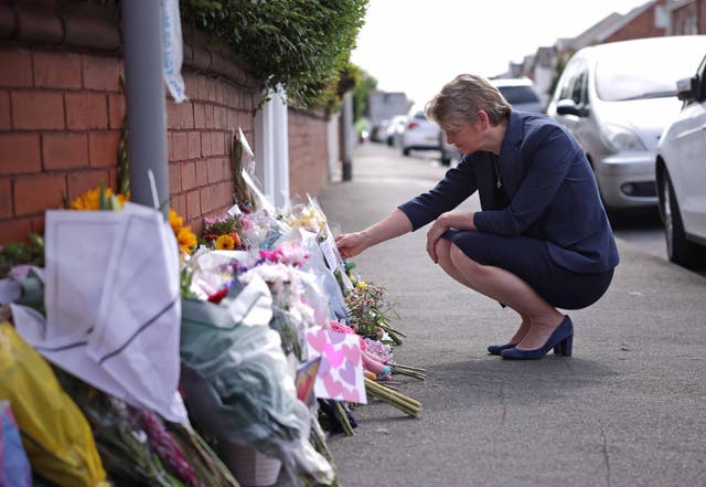 <p>Home Secretary Yvette Cooper looks at tributes near the scene in Hart Street</p>