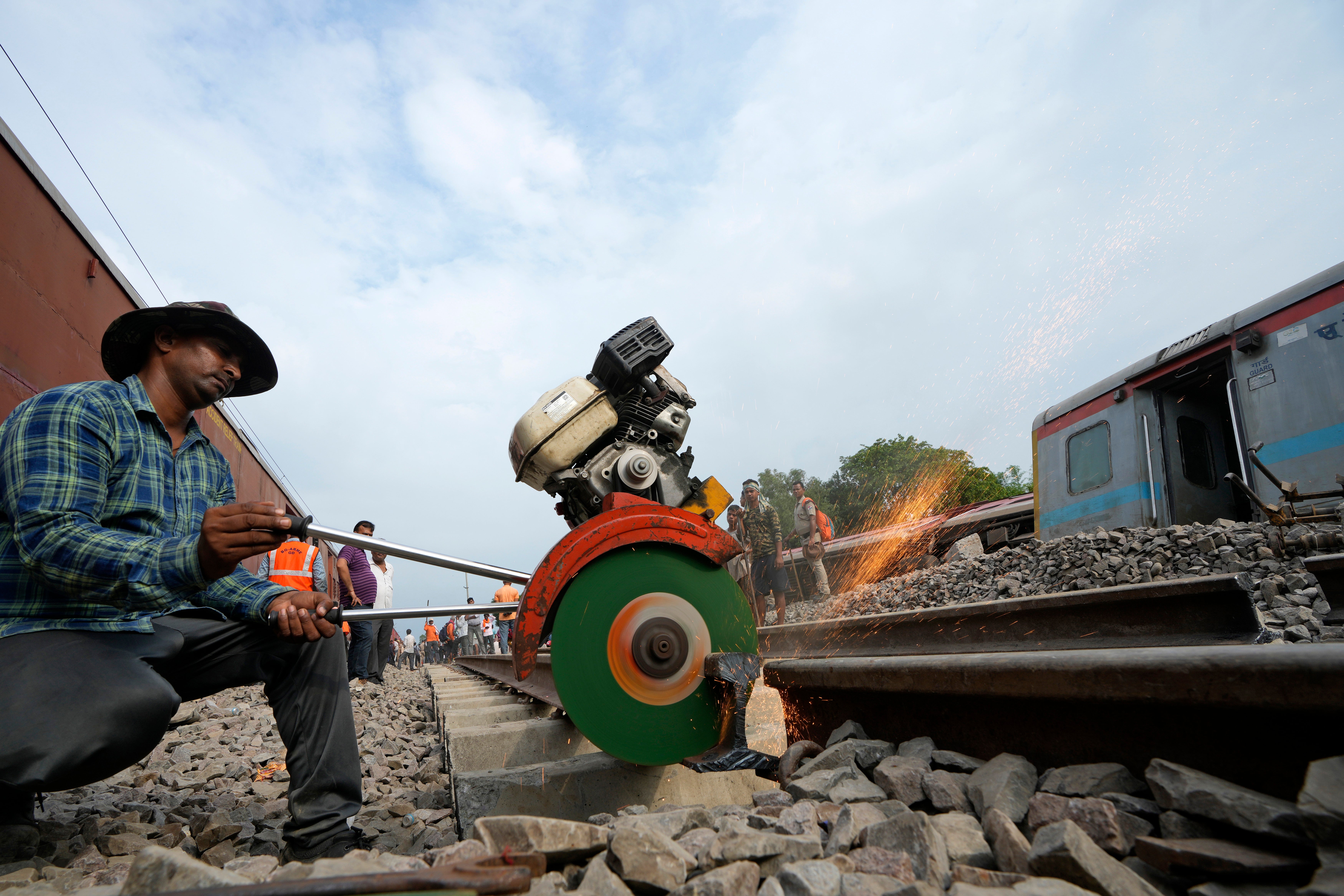 A worker repairs a railway track following a passenger train accident in Uttar Pradesh, India, on 19 July 2024