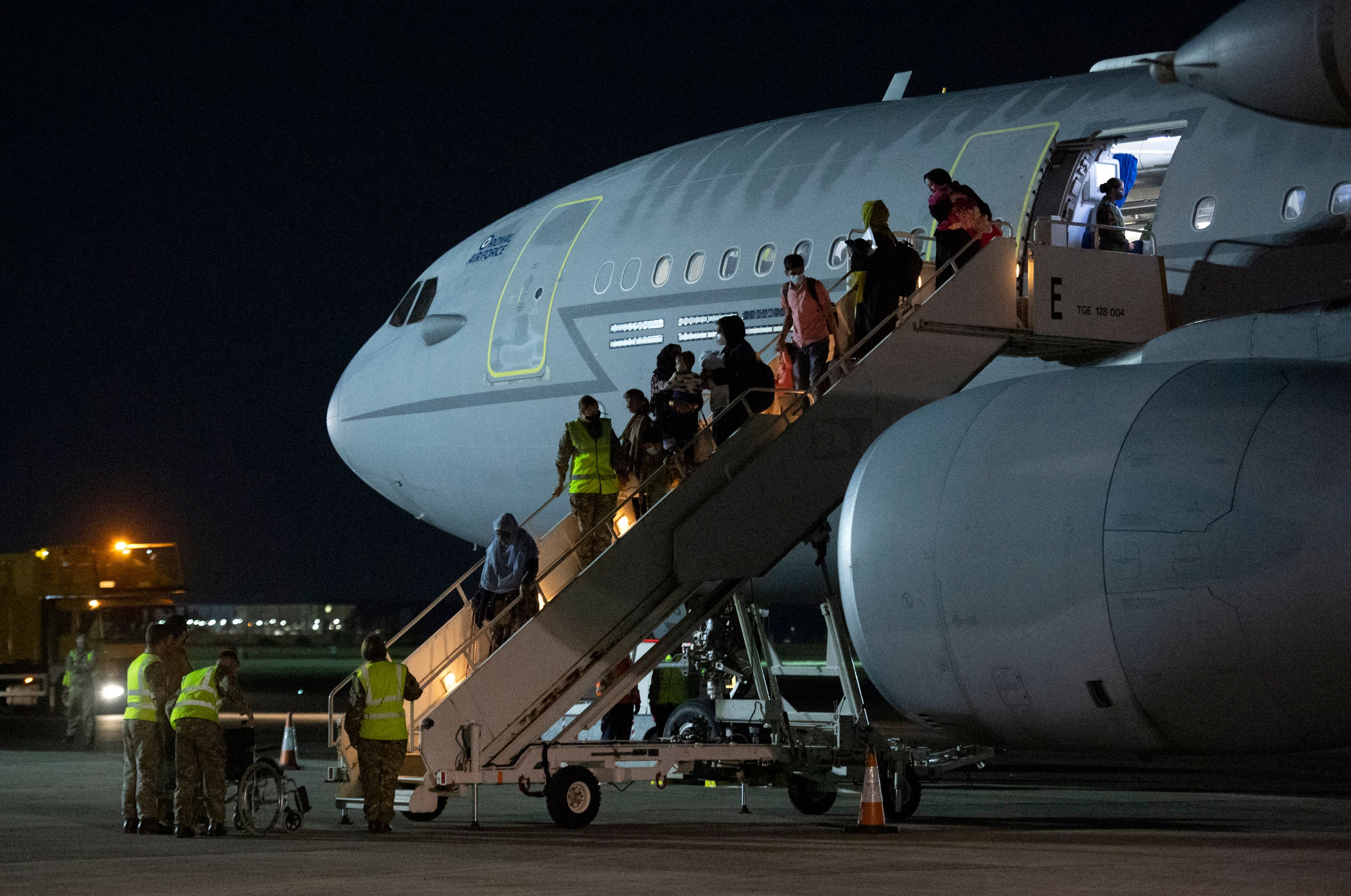 Passengers evacuated from Afghanistan disembark from a British Royal Air Force (RAF) Airbus KC2 Voyager aircraft