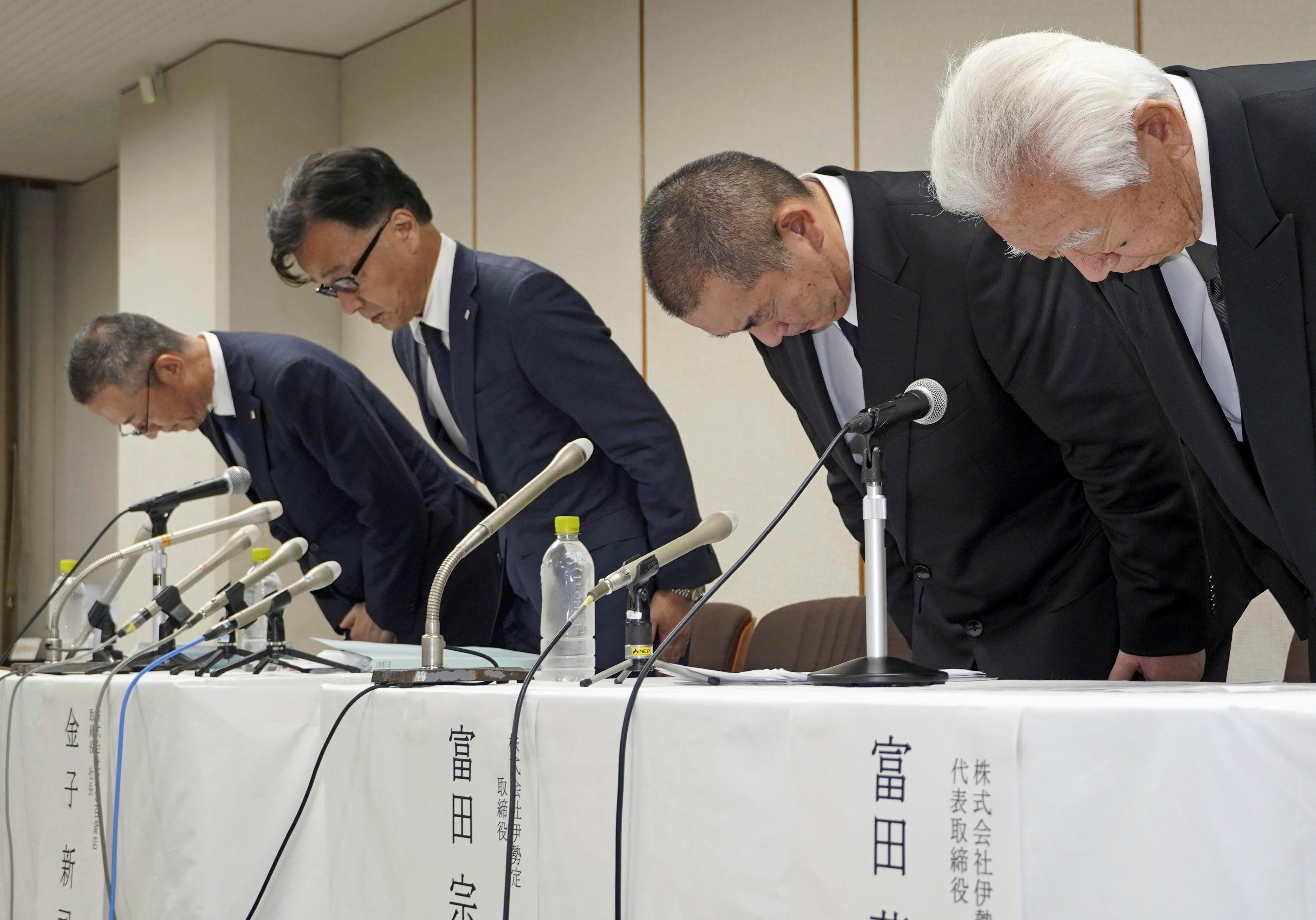 Shinji Kaneko, second left, President of Keikyu Department Store Co. bows during a press conference in Yokohama