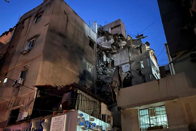 <p>A general view shows a damaged building that was hit by an Israeli airstrike in the southern suburbs of Beirut</p>