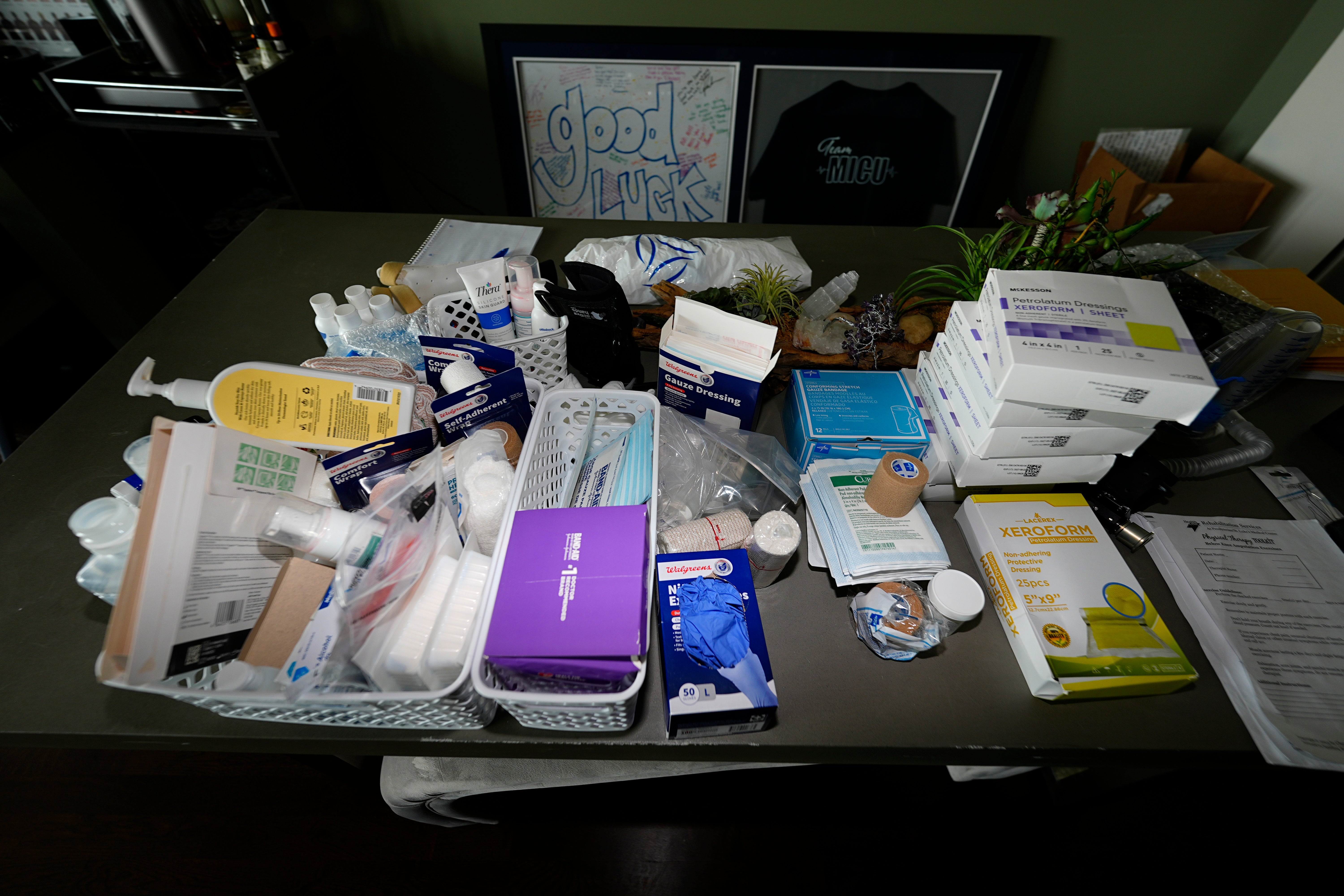 An array of medical needs sits on the table of Victor Moses in his apartment