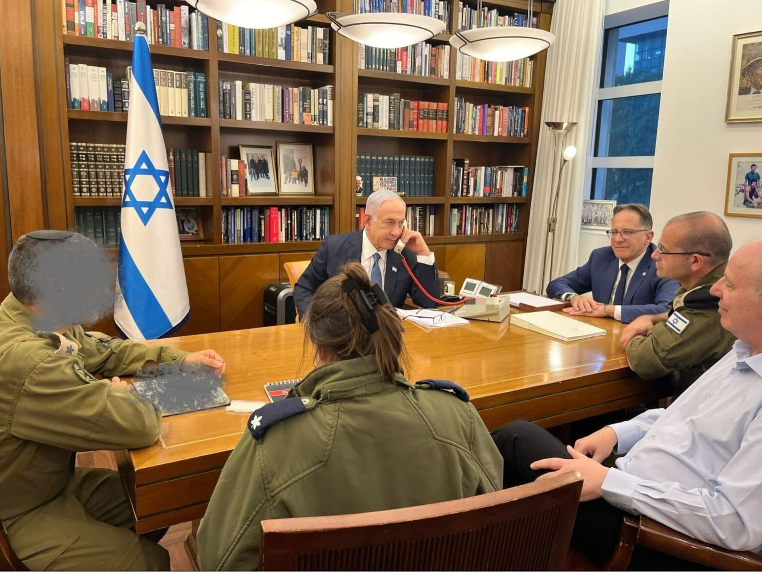 A handout image published by Netanyahu’s office shows the Israeli PM alongside senior military personnel earlier today