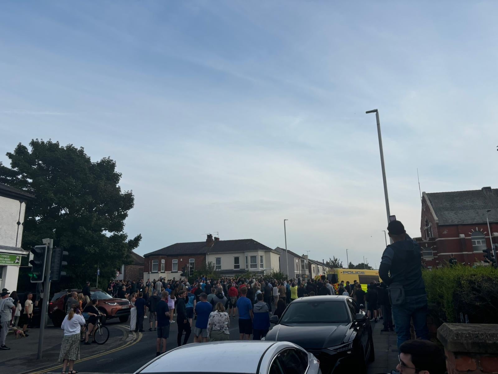 A police van has been set on fire as protesters set off fireworks and throw bricks