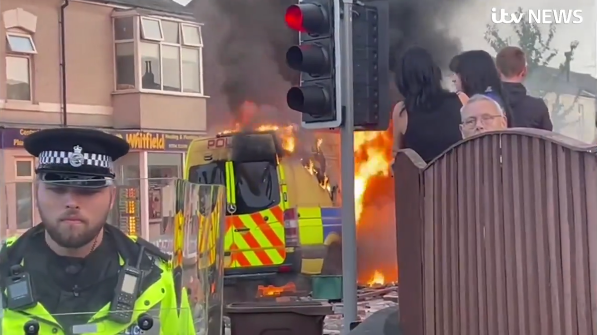 Flames engulf police van as Southport protesters clash with officers outside mosque