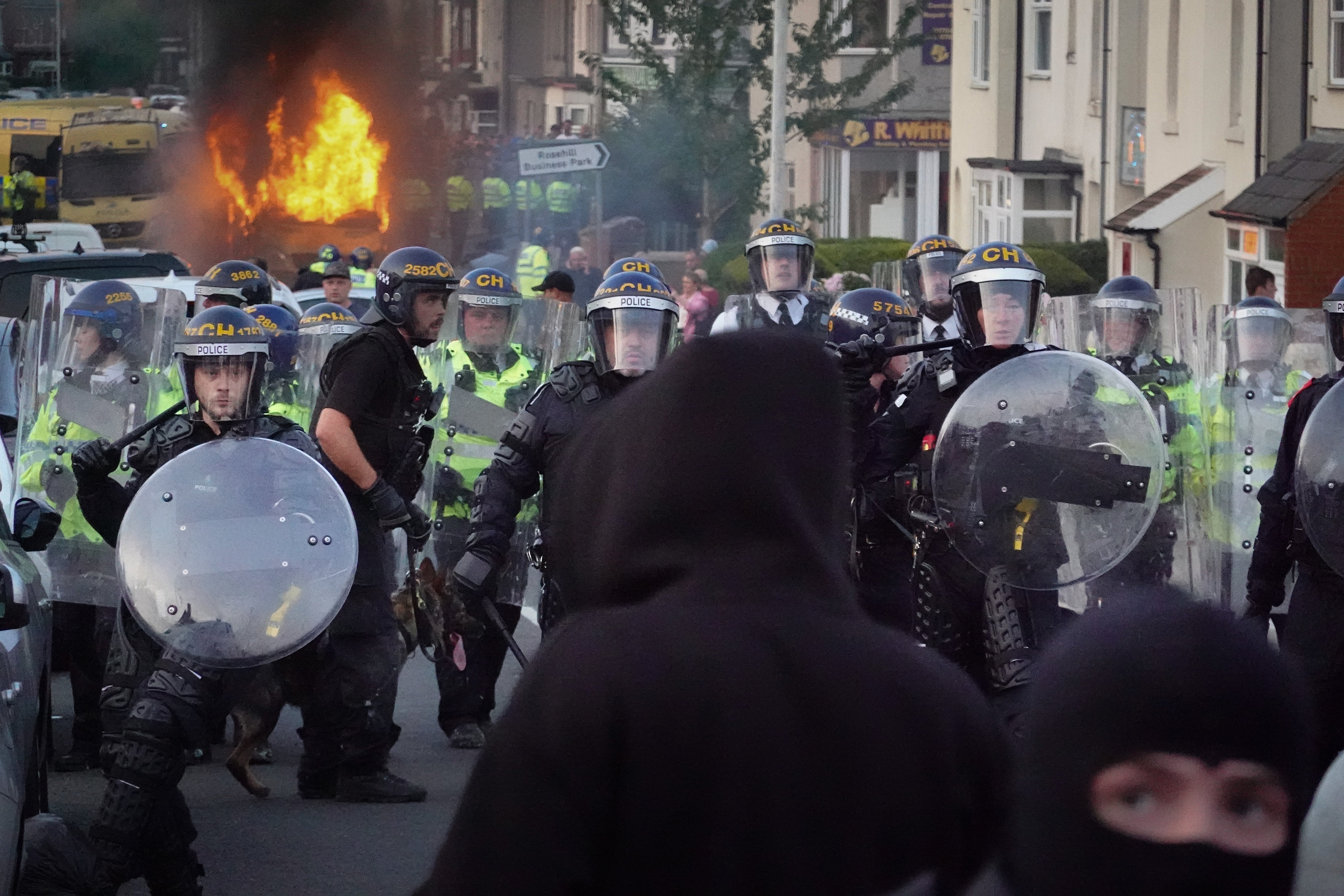 Riot police hold back protesters after disorder broke out in Southport