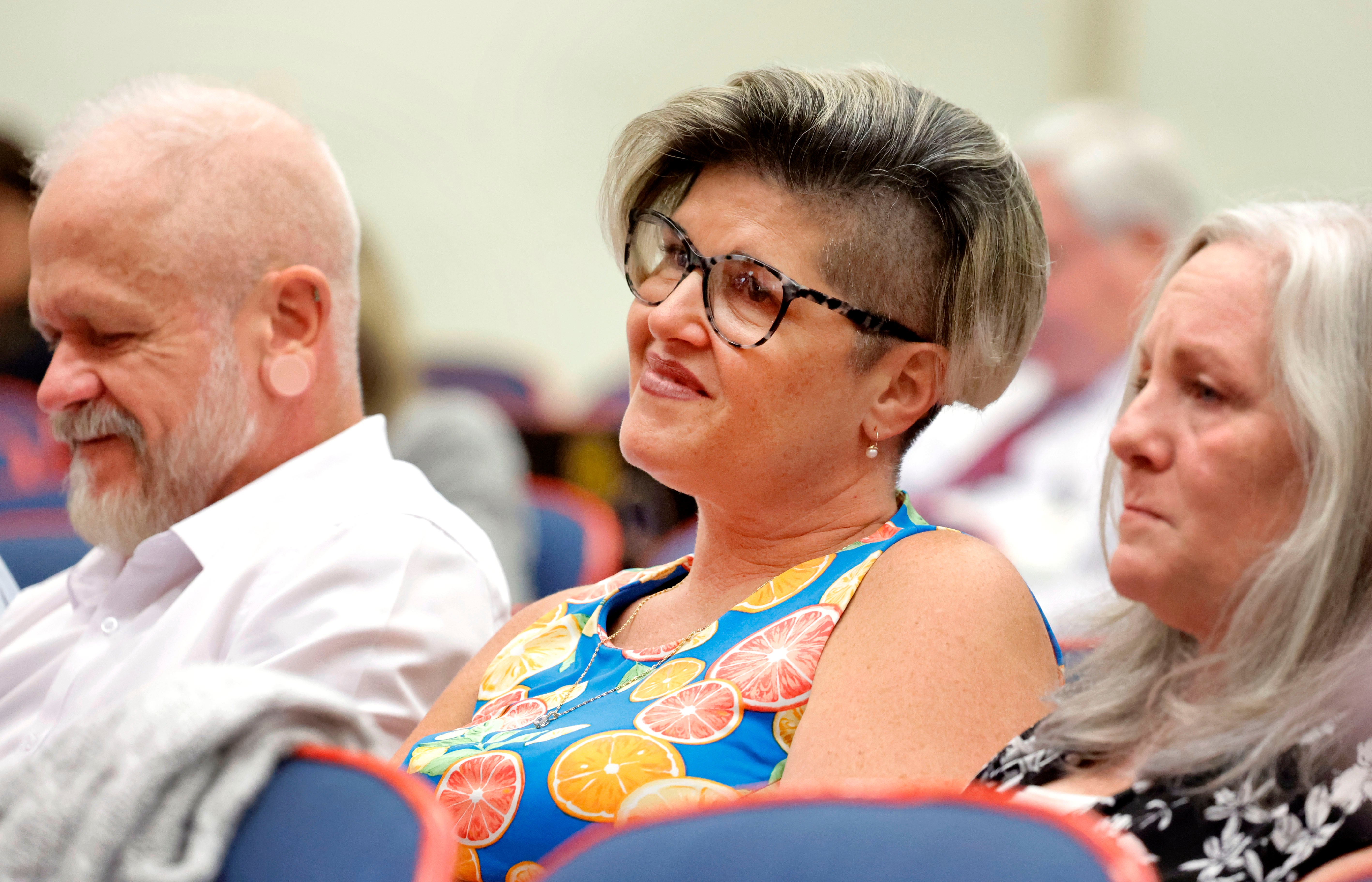 Jessica Norton and her husband Gary, listen as Broward County school board members discuss her fate