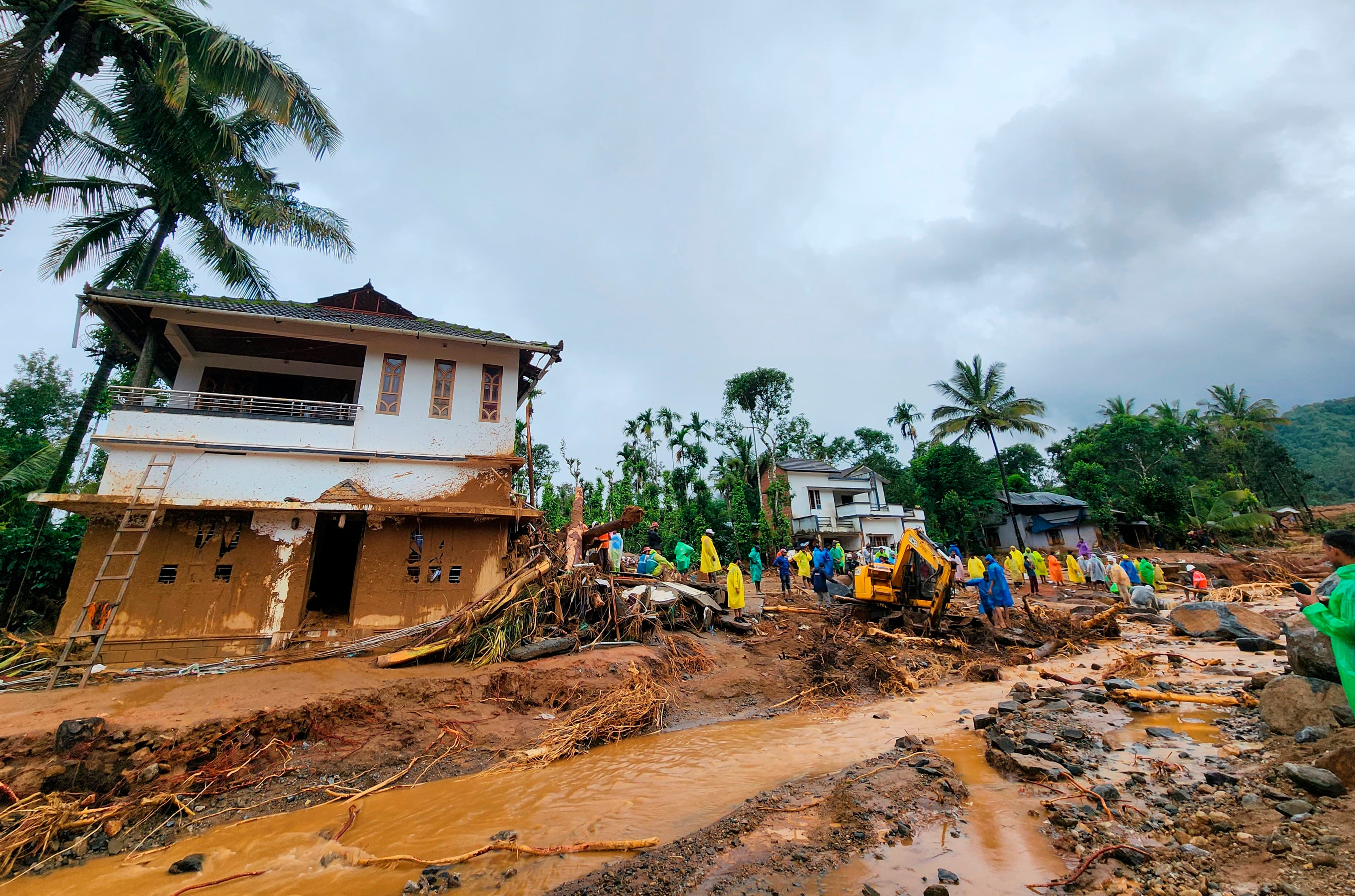 Rescuers work at the spot after landslides hit hilly villages in Wayanad district, Kerala state, India