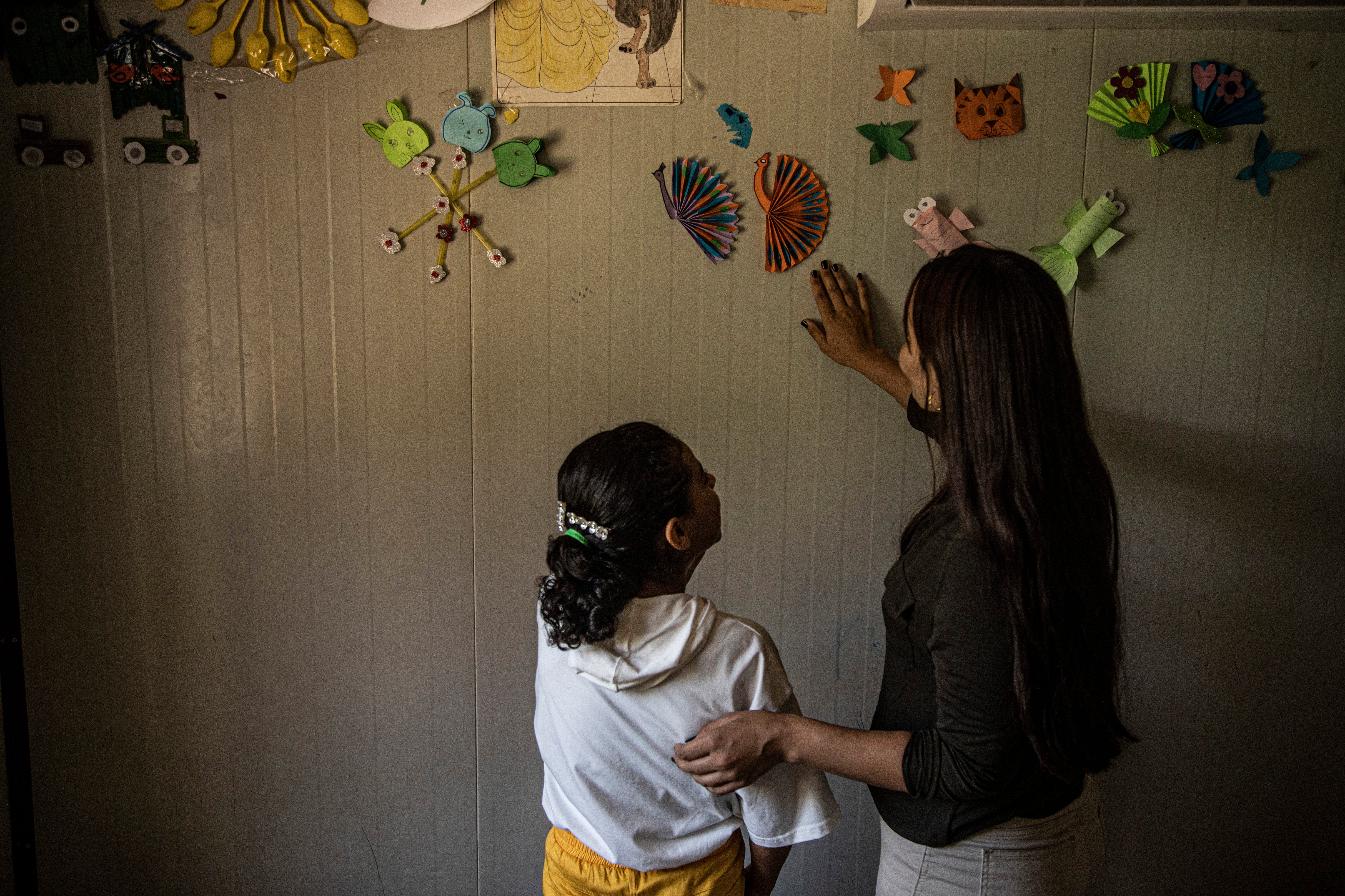 A Yazidi girl displays her handicrafts in northeastern, Syria, Wednesday, 26 June 2024