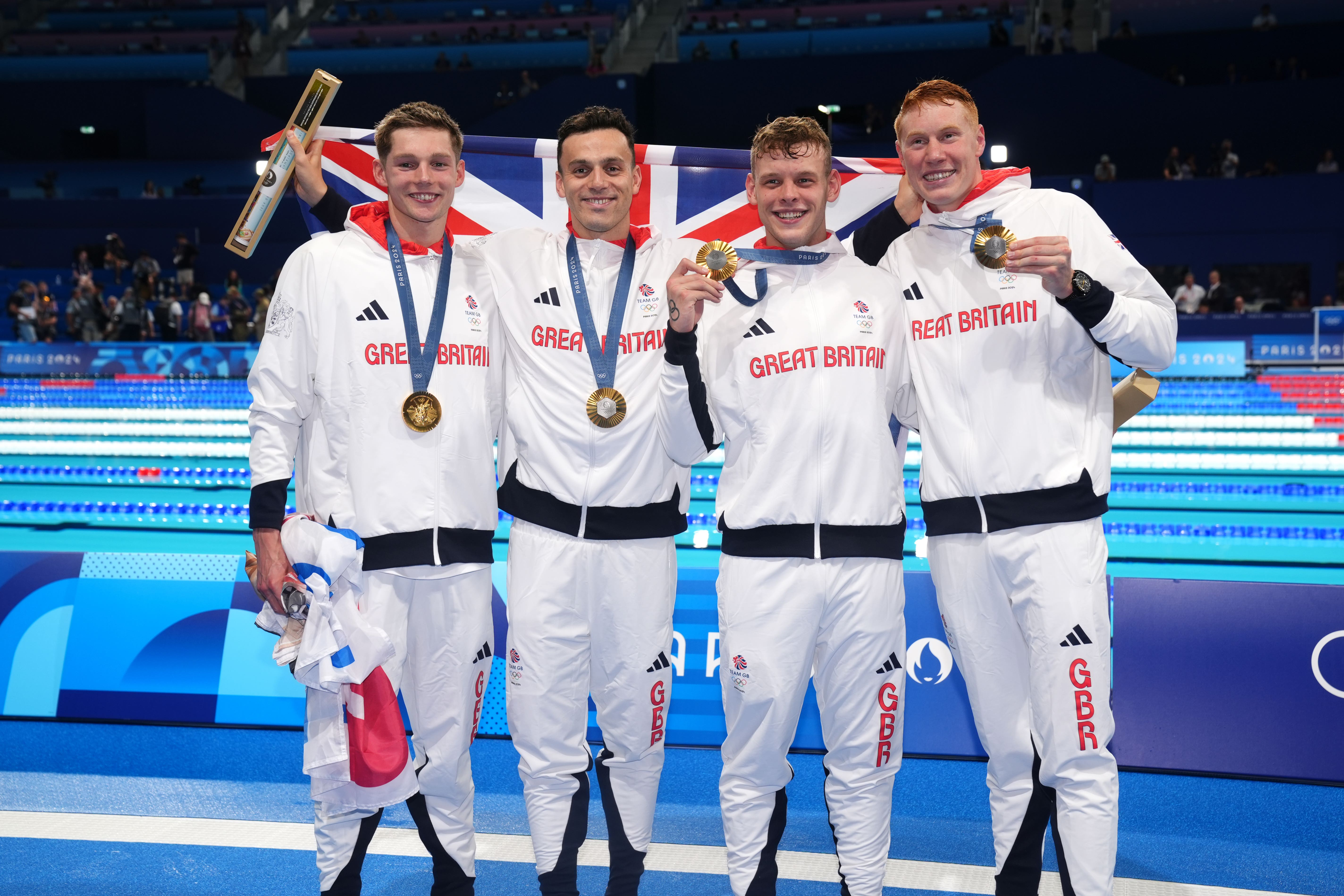 Duncan Scott, left, James Guy, Matt Richards and Tom Dean sealed Tram GB’s first Olympic gold in the pool at Paris 2024 (John Walton/PA)