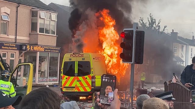 <p>A police van set alight as trouble flared during the far-right protest on Tuesday </p>