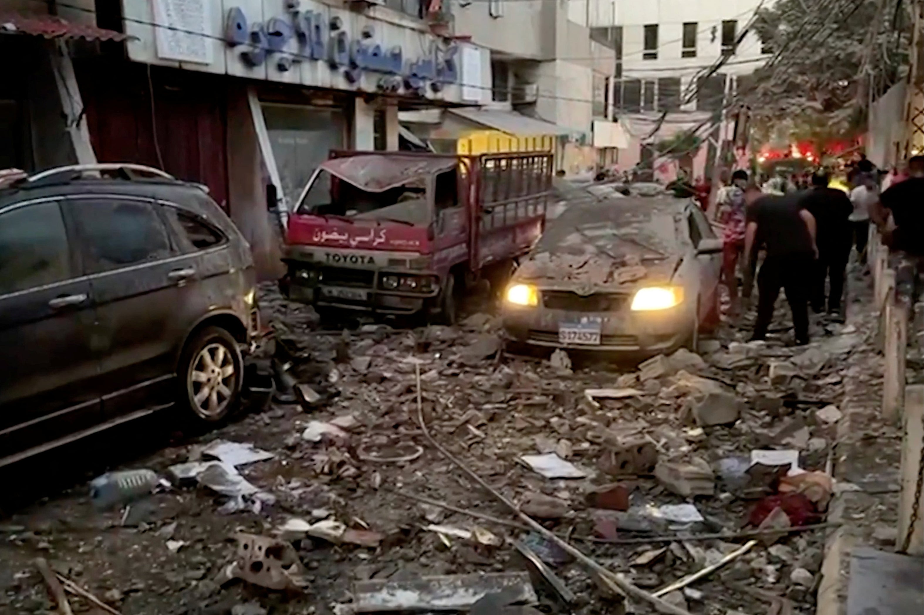 Damaged vehicles are seen after an Israeli strike on Beirut’s southern suburbs