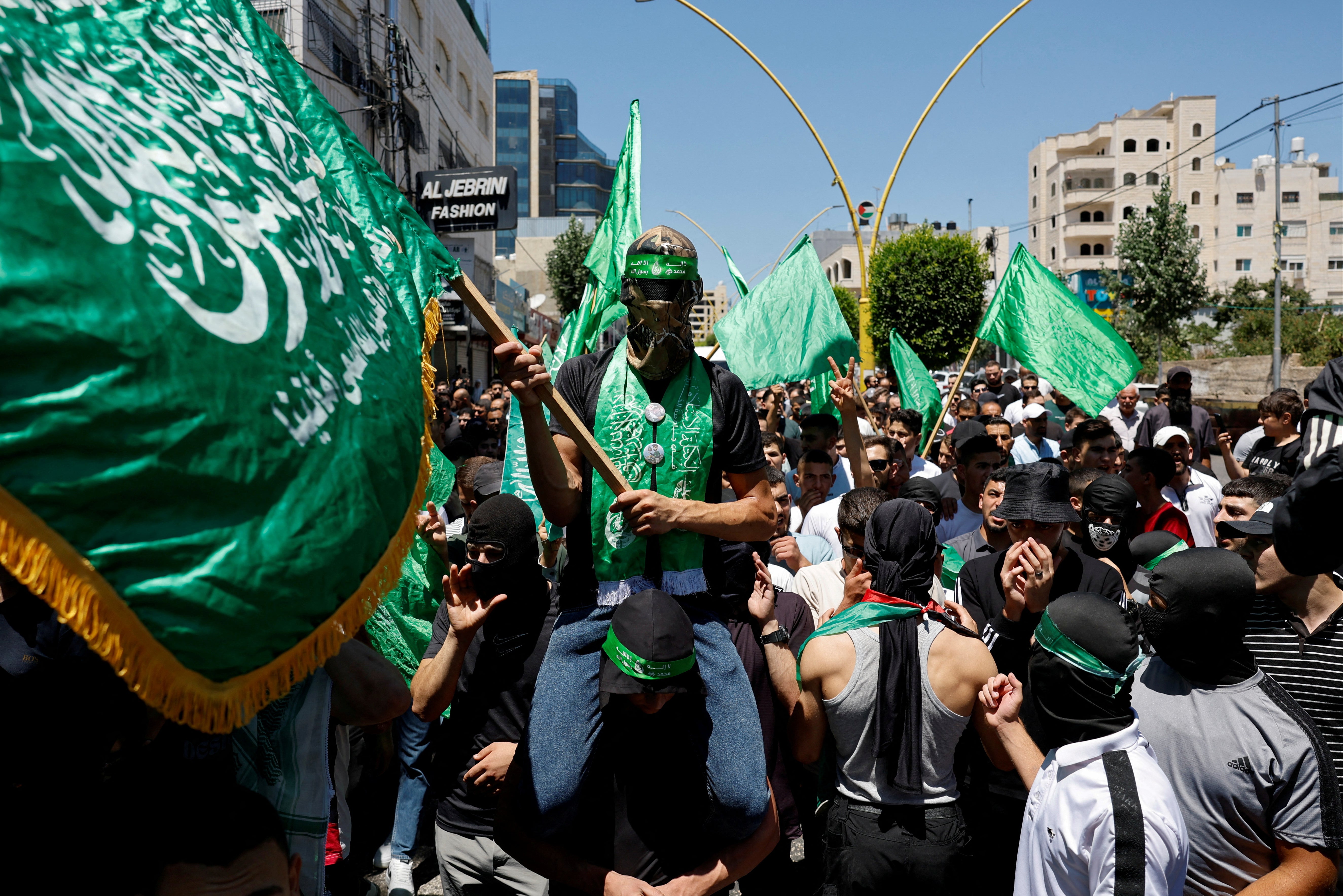 Palestinians attend a protest after the assassination of Hamas leader Ismail Haniyeh in the occupied West Bank