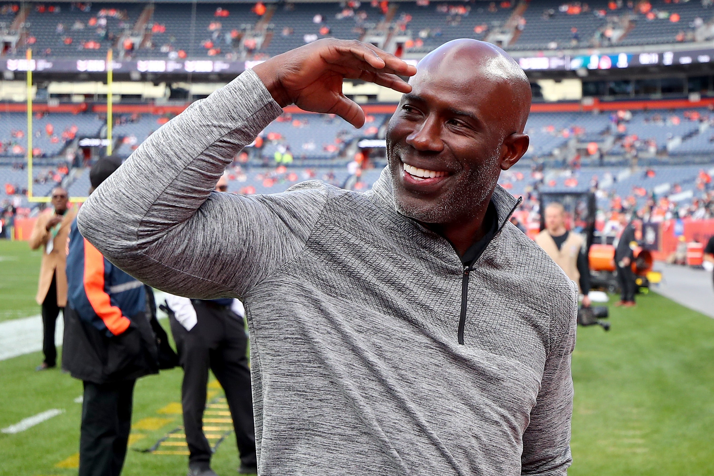 Former Denver Broncos star Terrell Davis, pictured, was taken off a plane in handcuffs after he tapped a flight attendant on the shoulder during a July 13 United Airlines flight